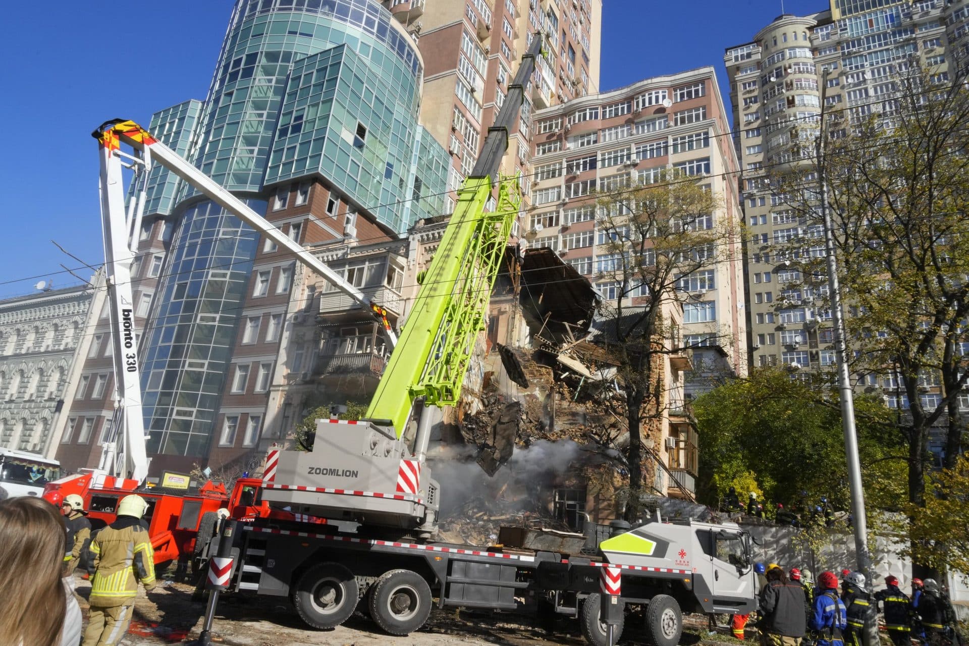 Firefighters work after a drone fired on buildings in Kyiv