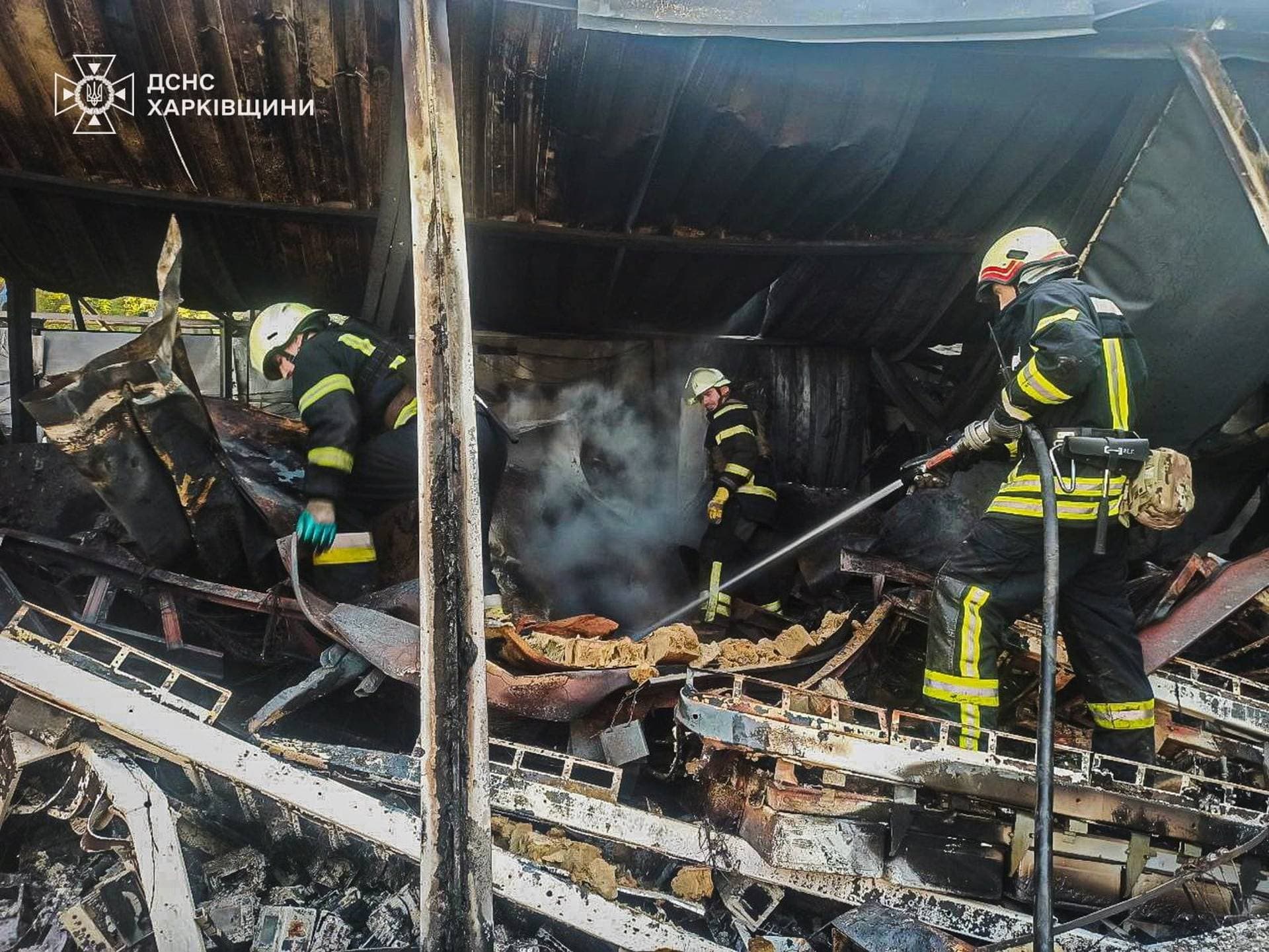Rescuers work at the site of a Russian drone strike, amid Russia's attack on Ukraine, in the town of Lozova