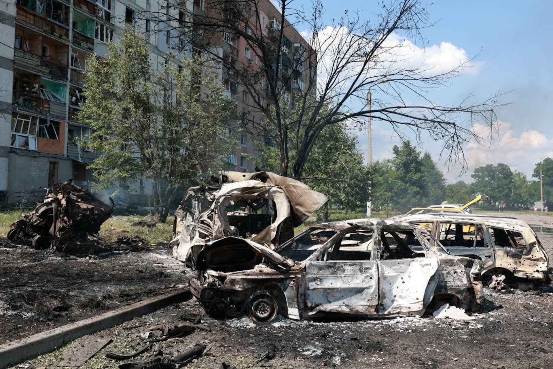 Burned-out cars at the site of a Russian military strike in the town of Pervomaiskyi