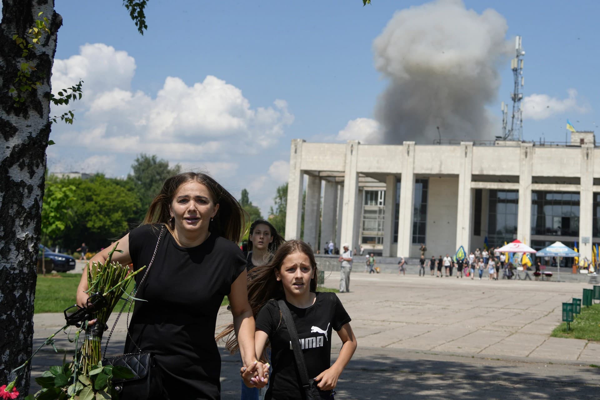 A family runs from an explosion in Pervomaiskyi