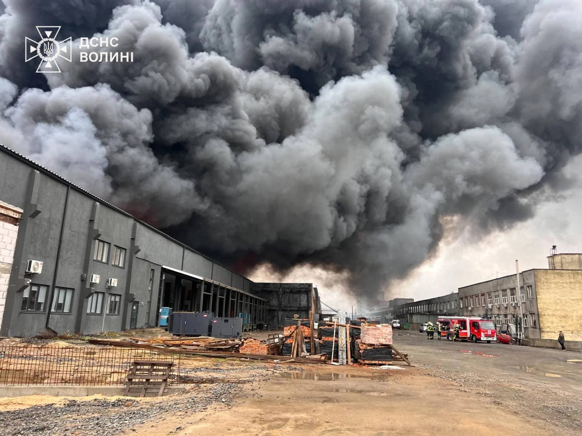 Firefighters work at the site of a Russian drone strike in Lutsk
