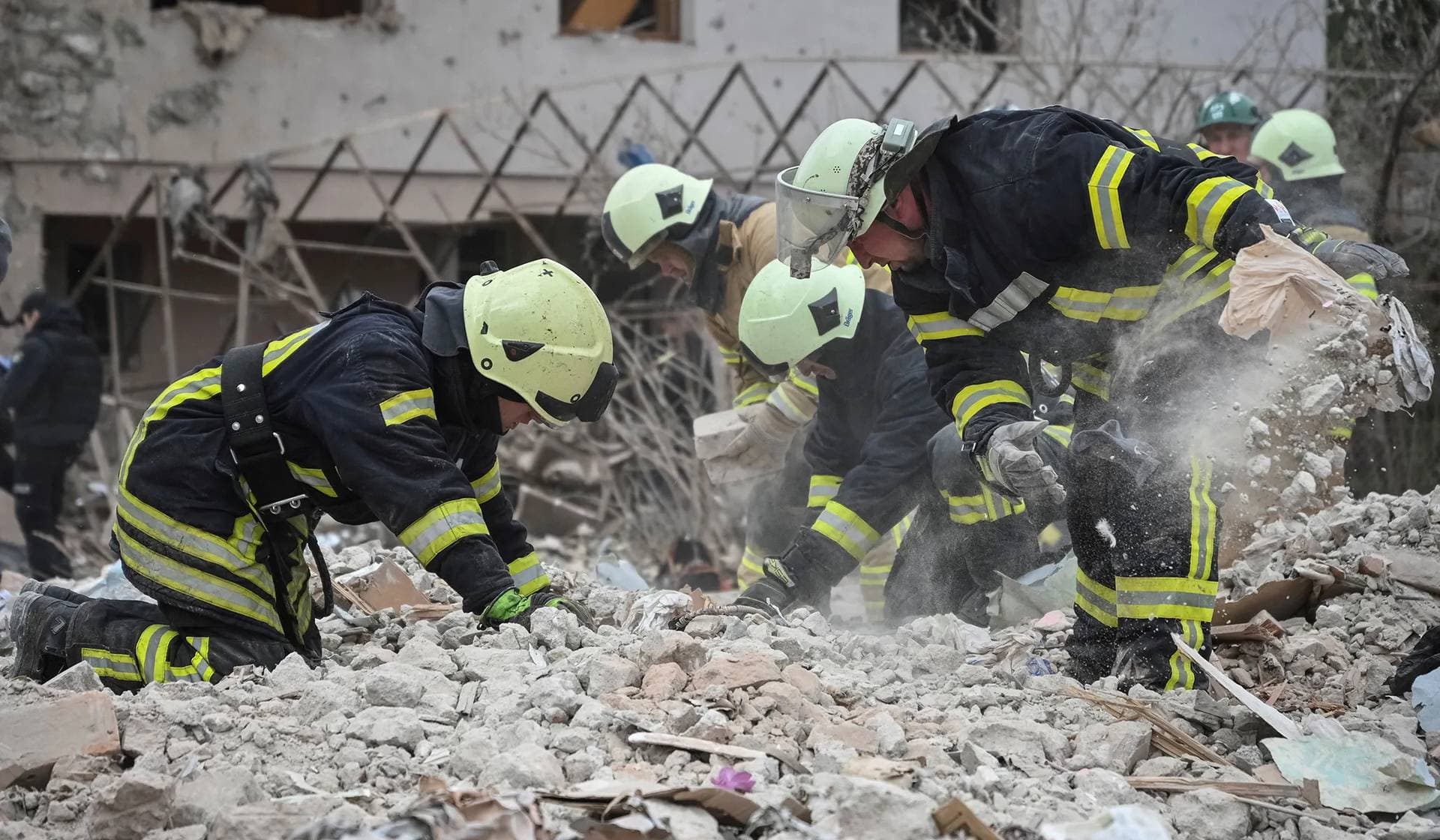 Rescuers work at the site of a house destroyed during a Russian drone and missile strike in the village of Lapaivka