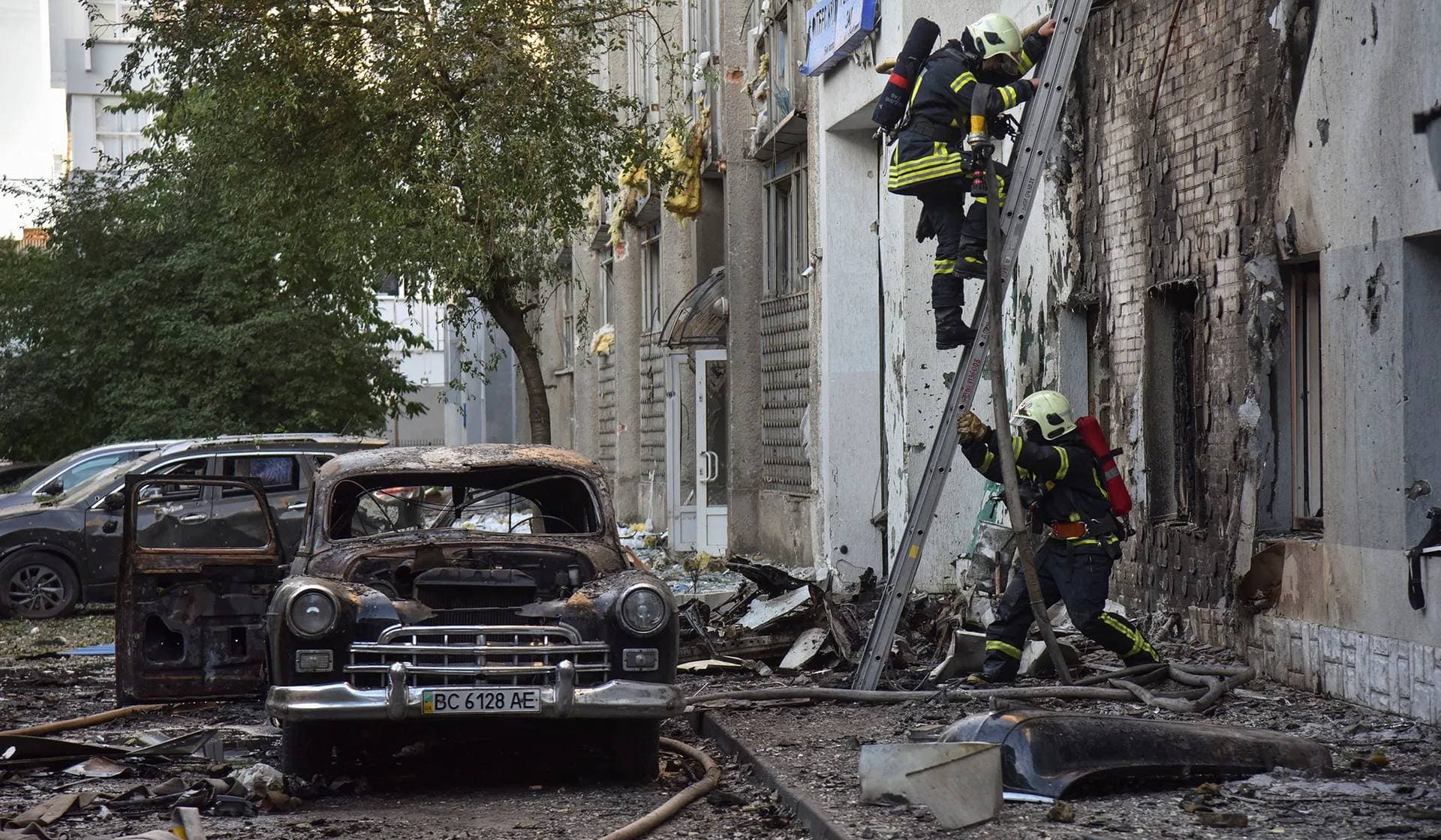 Firefighters work at the site of buildings damaged during Russian drone and missile strikes in Lviv