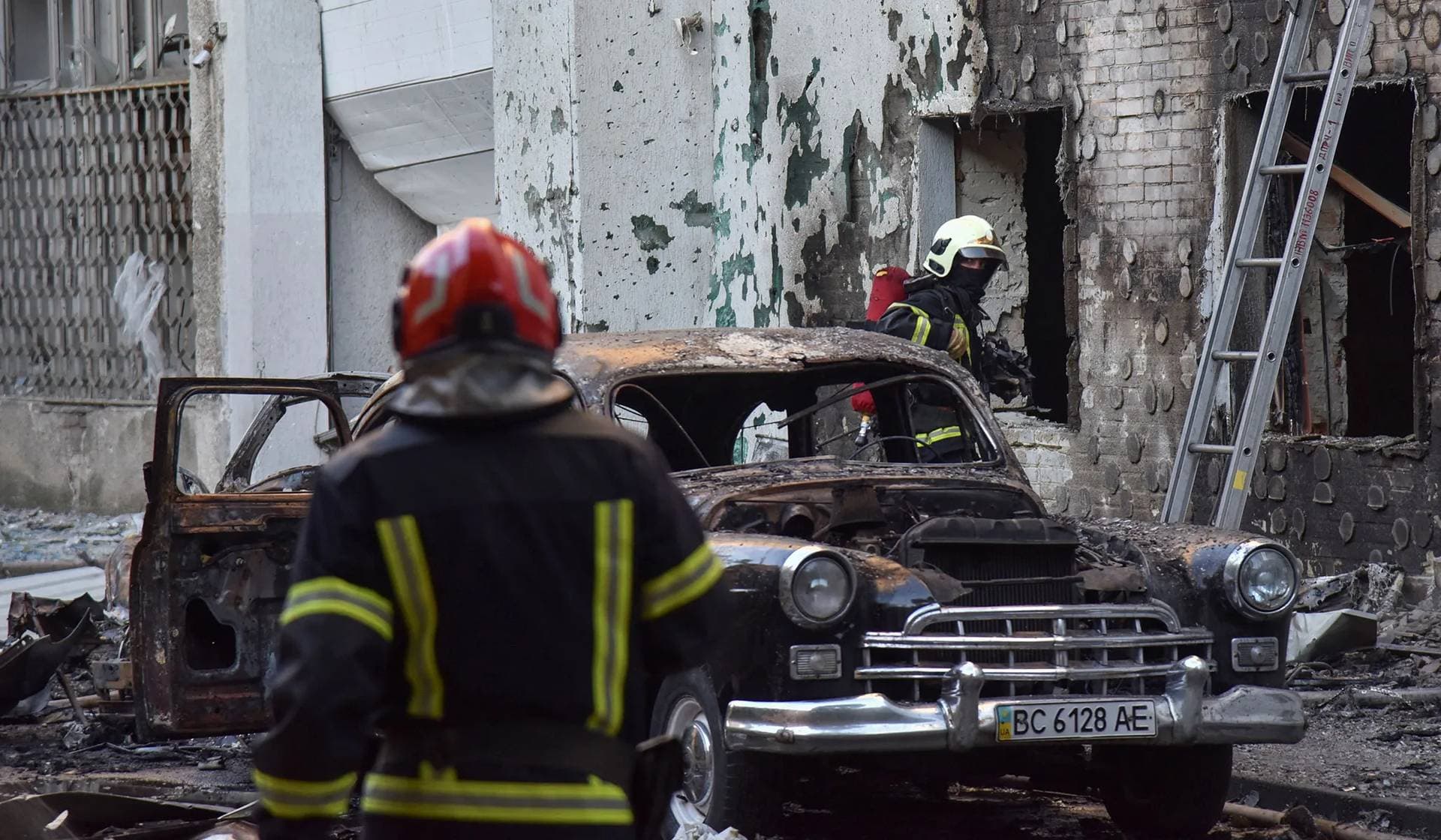Firefighters work at the site of buildings damaged during Russian drone and missile strikes in Lviv