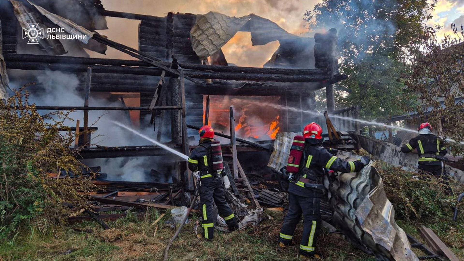 A firefighter works at the site of a residential area hit during Russian drone and missile strikes in Lviv Region