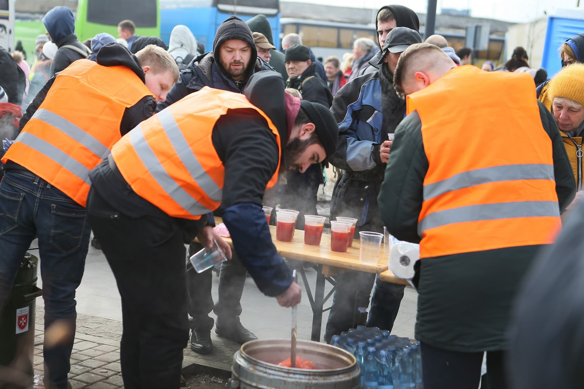 Volunteers distribute hot meals to refugees at a refugee center in Lviv