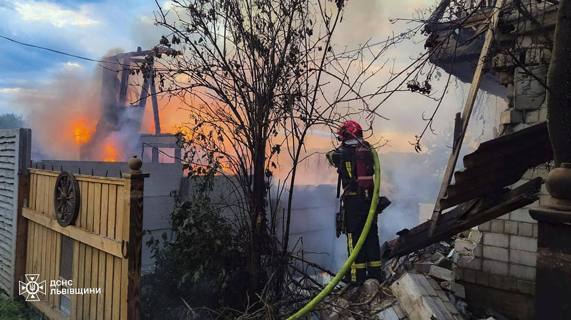 A firefighter works at the site of a residential area hit during Russian drone and missile strikes in Lviv Region