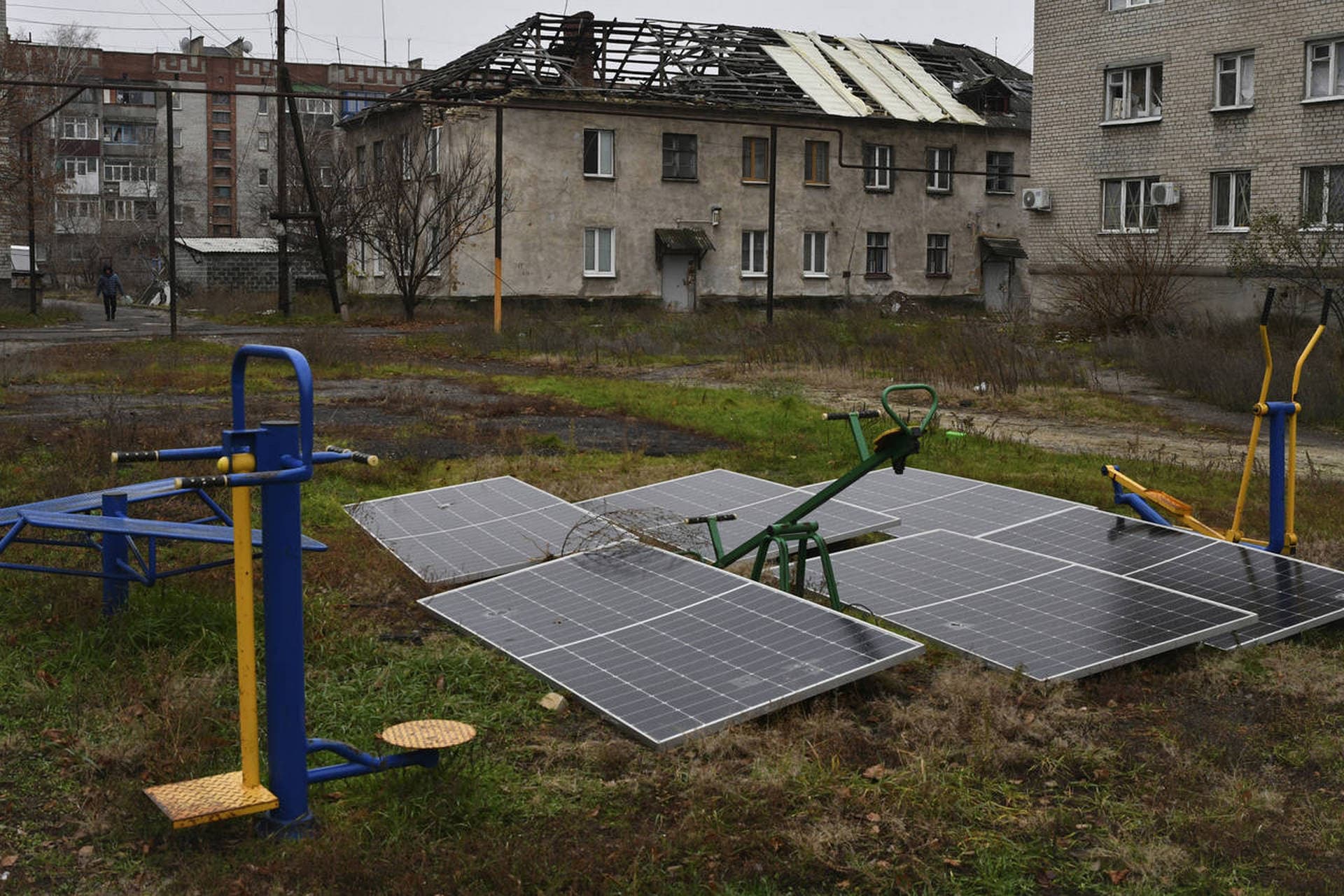 Solar panels seen in the yard of an apartment building in Lyman