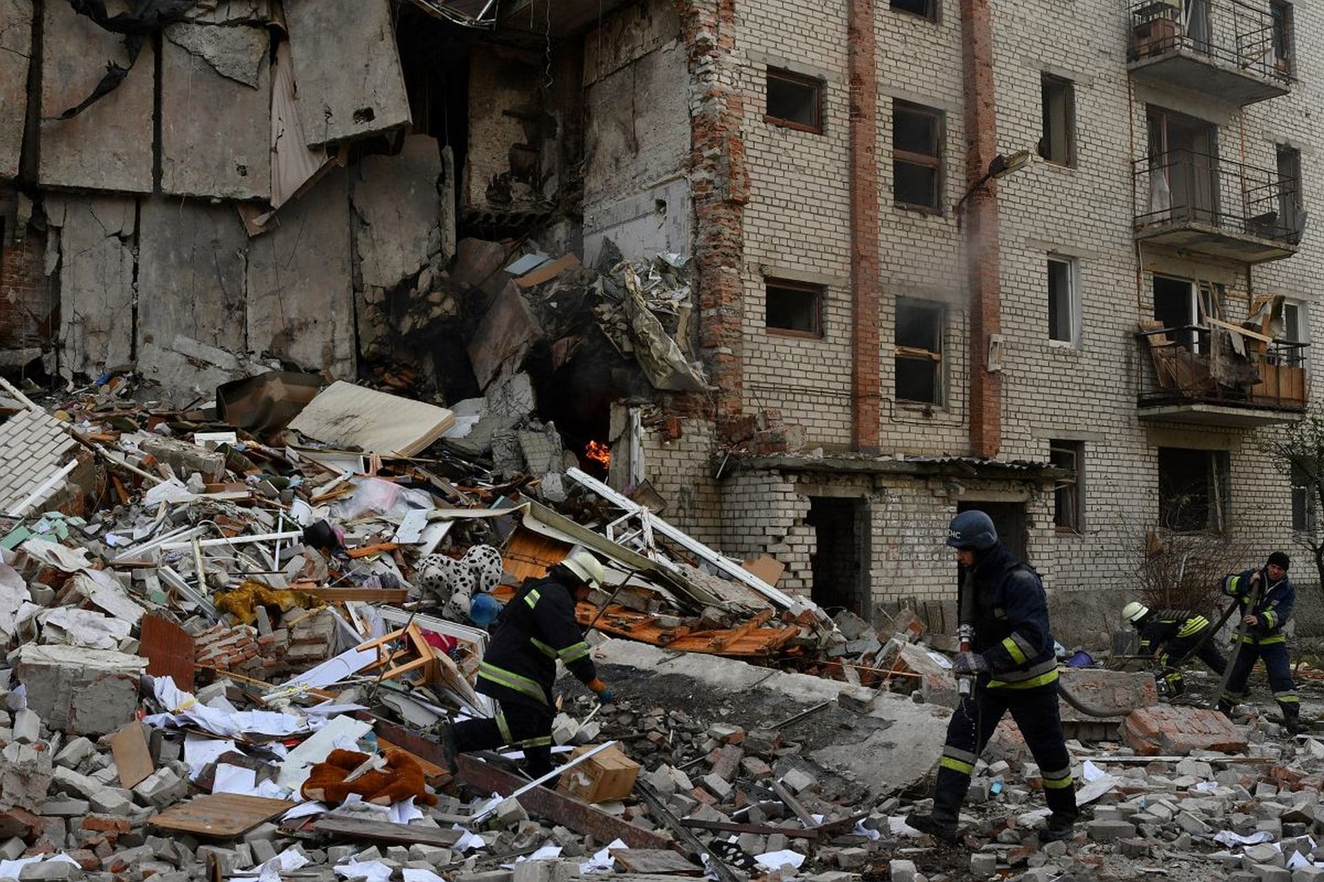 Firefighters work at the scene of a damaged residential building after Russian shelling in the liberated Lyman