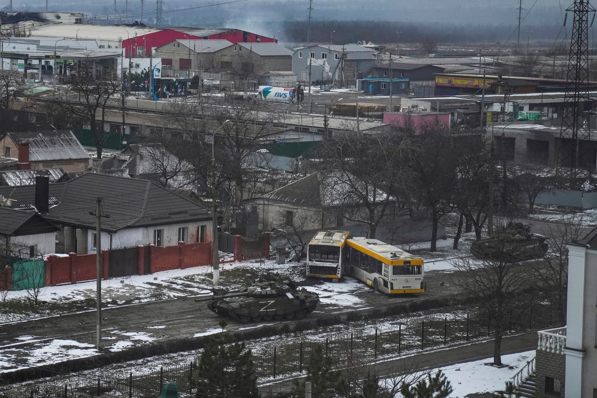 Russian Army tanks move through a street on the outskirts of Mariupol