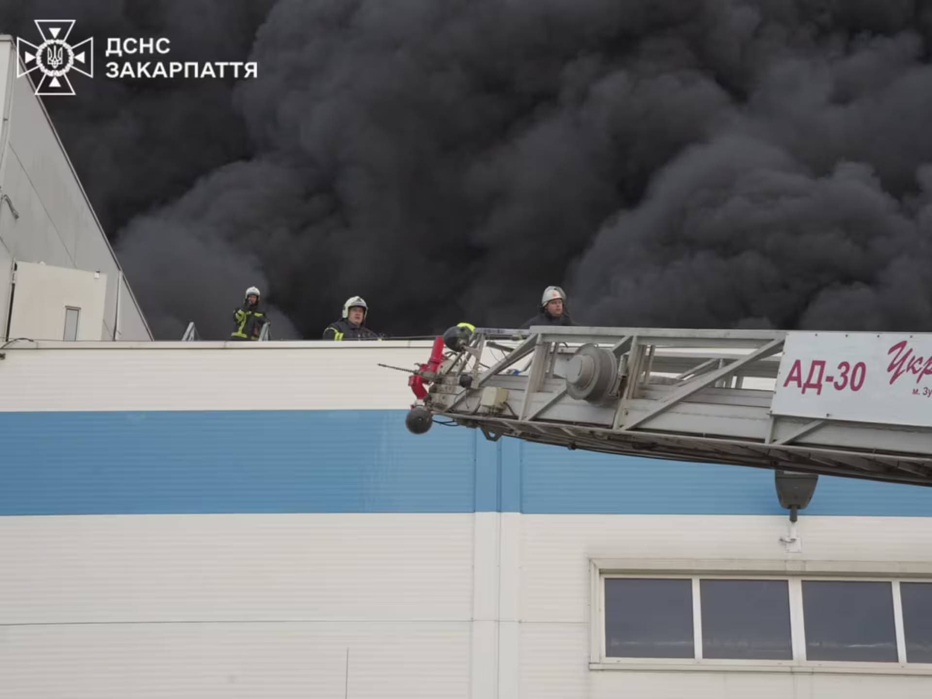Firefighters work at the site of a Flextronics factory hit by a Russian missile strike in Mukachevo