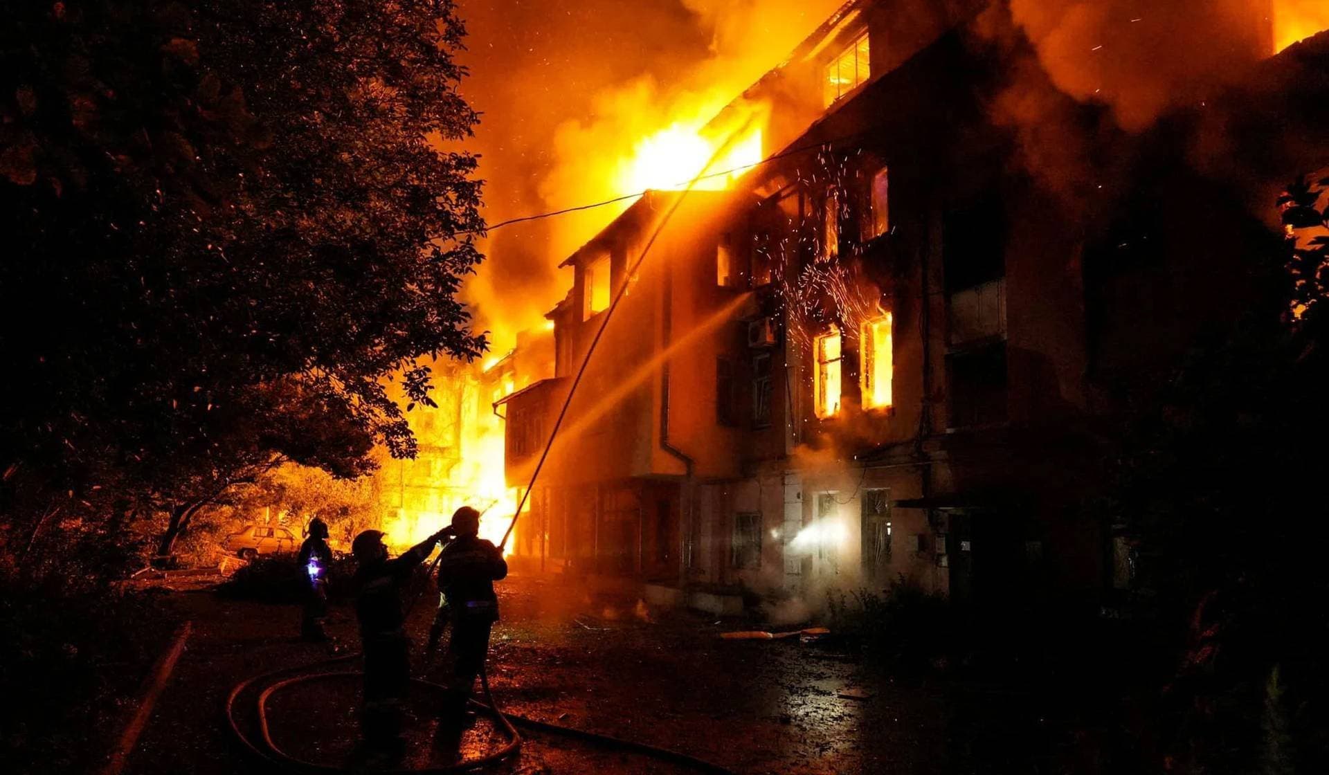 Firefighters work at a site of a residential building heavily damaged by a Russian missile strike in Mykolaiv