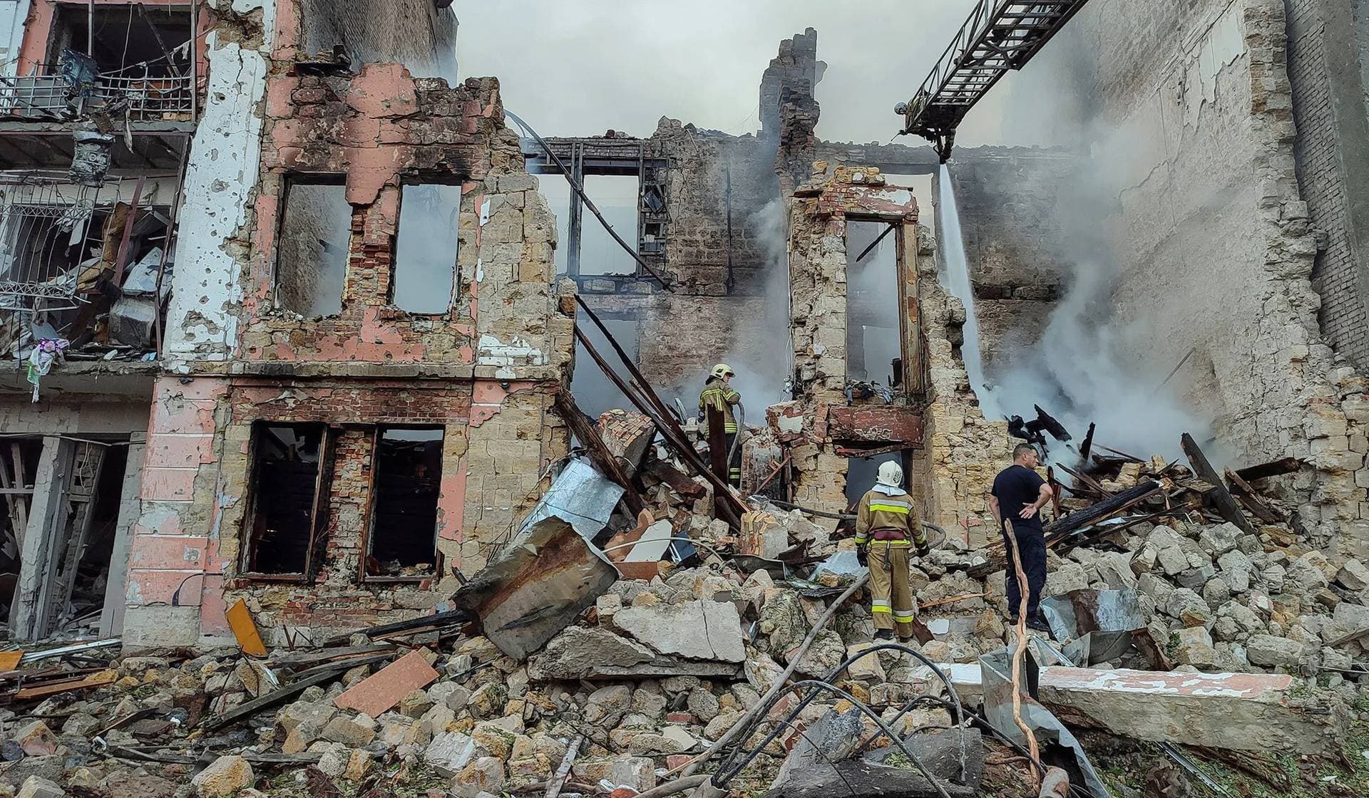 Rescuers work at a site of a residential building heavily damaged by a Russian missile attack in Mykolaiv