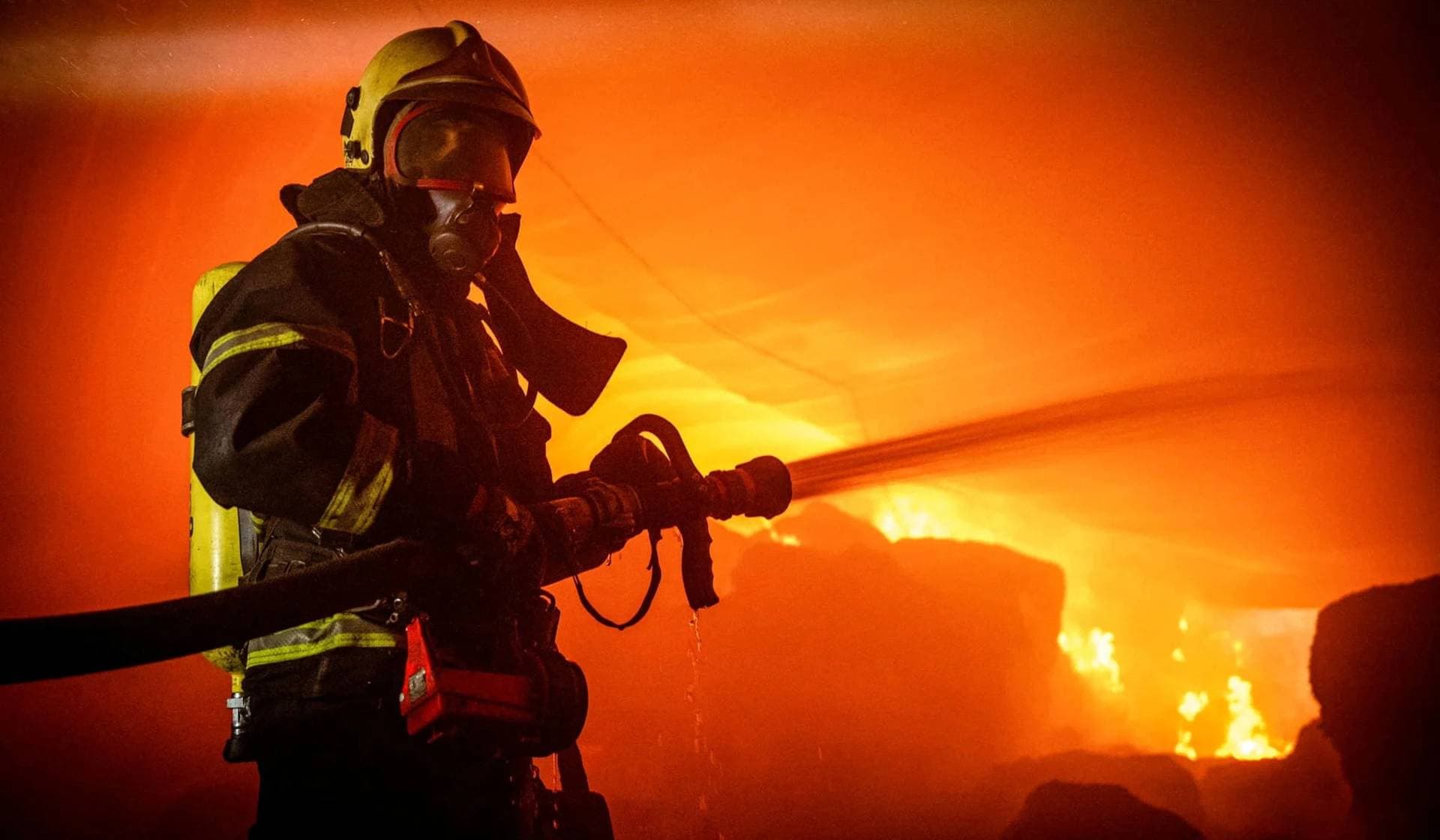 A firefighter works at a site of storage facilities hit during Russian missile and drone strikes in Odesa