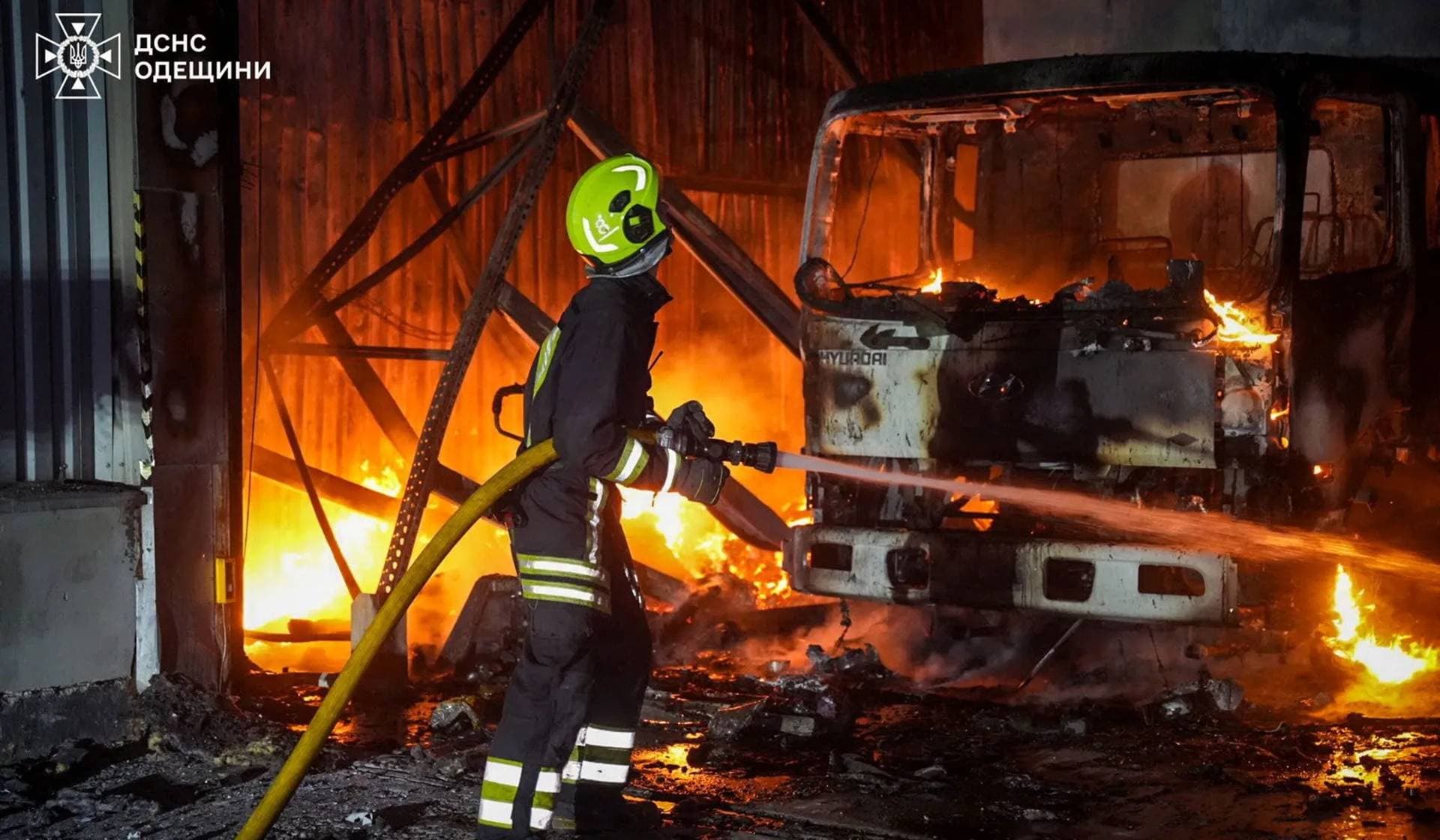A firefighter works at the site of a warehouse hit by a Russian drone strike in Odesa