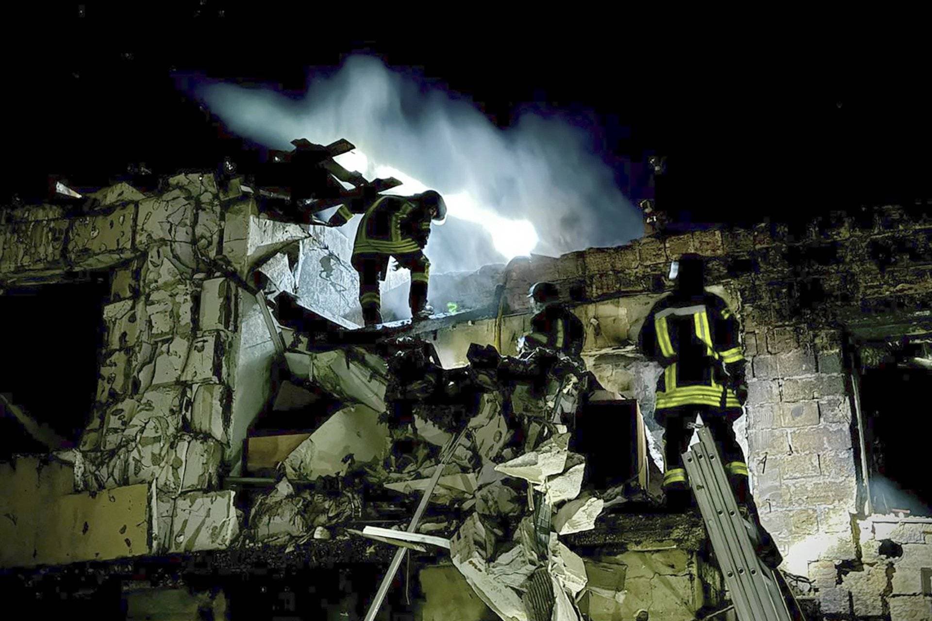 Rescuers work at a site of residential buildings destroyed during a Russian drone strikes in Odesa