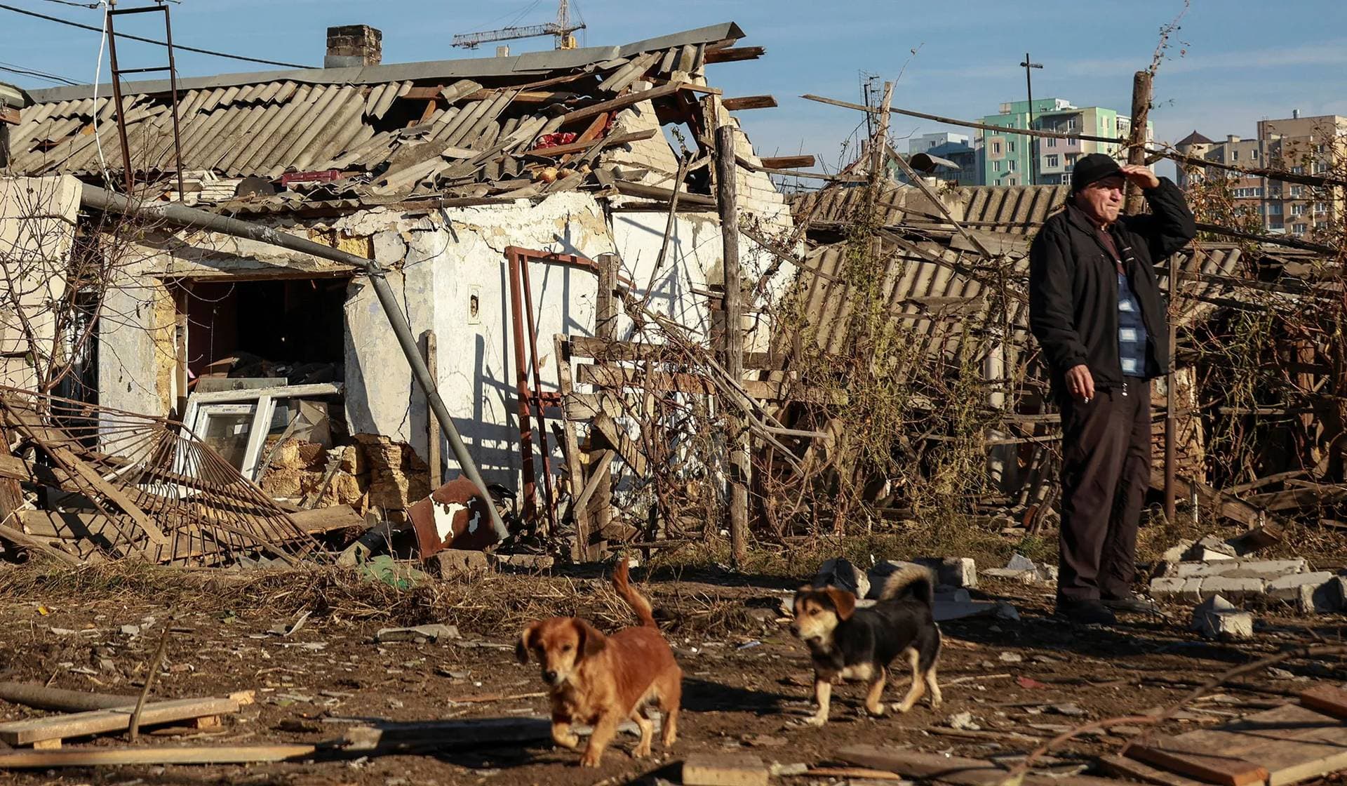A resident stands next to houses damaged by a Russian drone strike in Odesa
