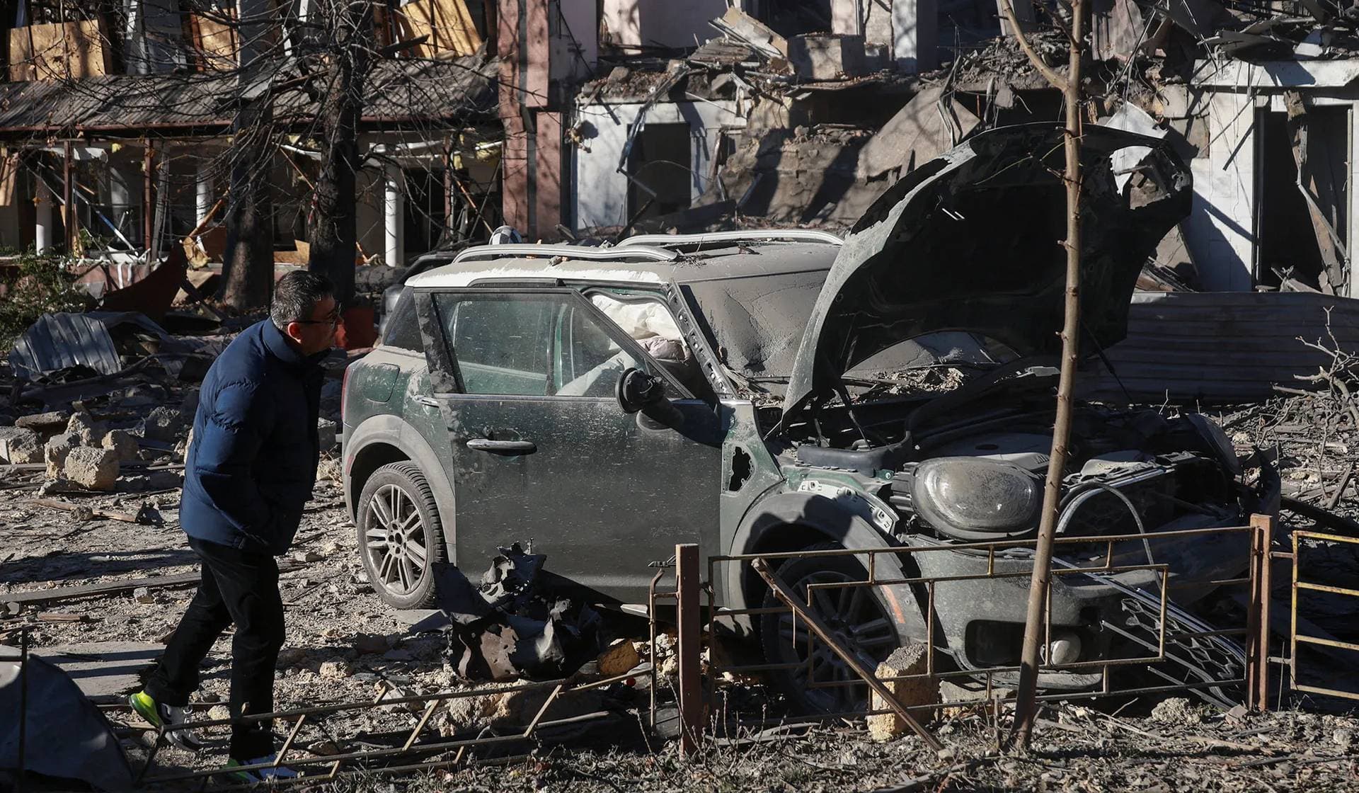 A resident looks at a car damaged during a Russian missile strike in Odesa
