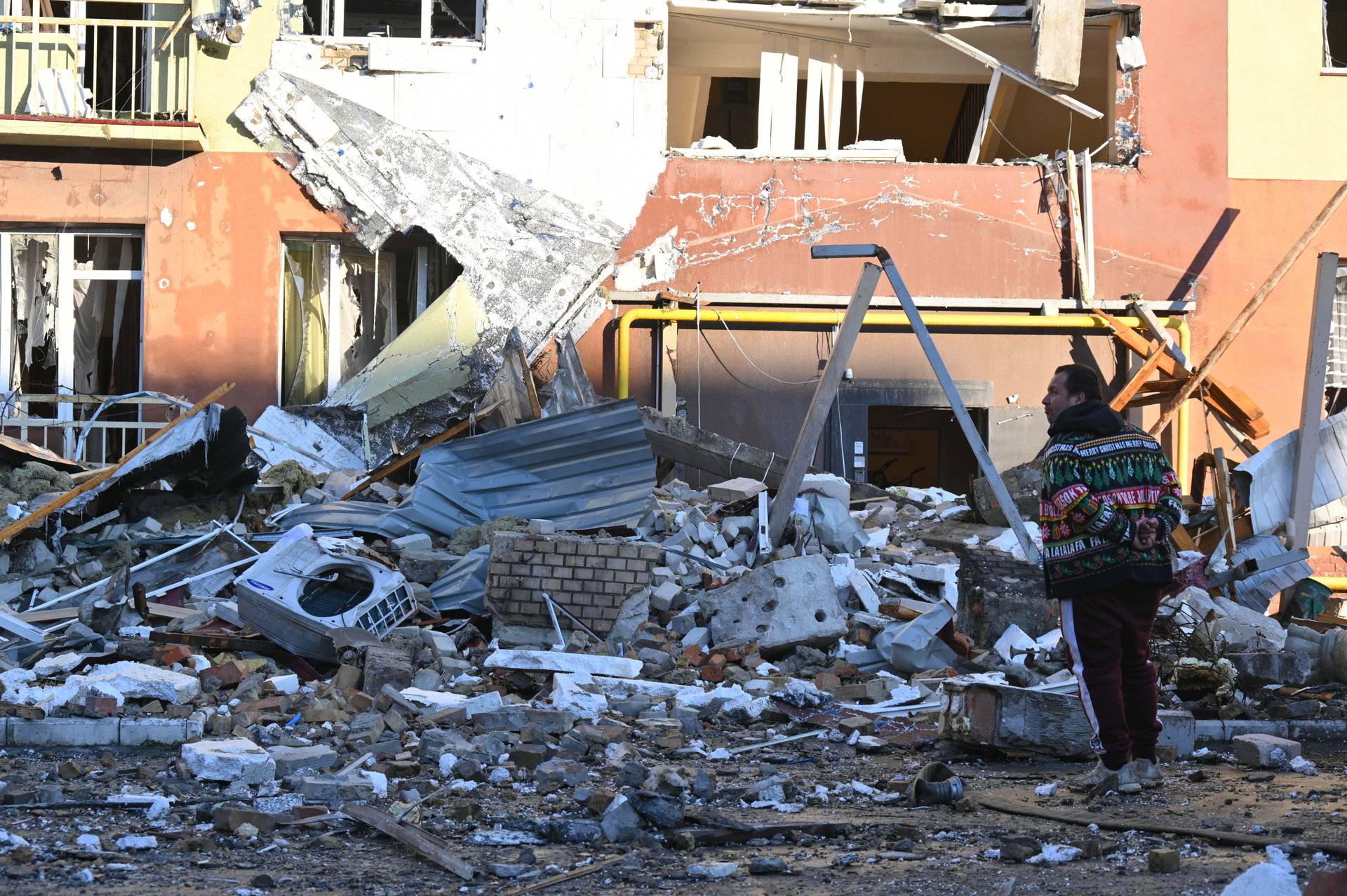 A local man stands in front of residential building which was heavily damaged after a Russian strike in Odesa