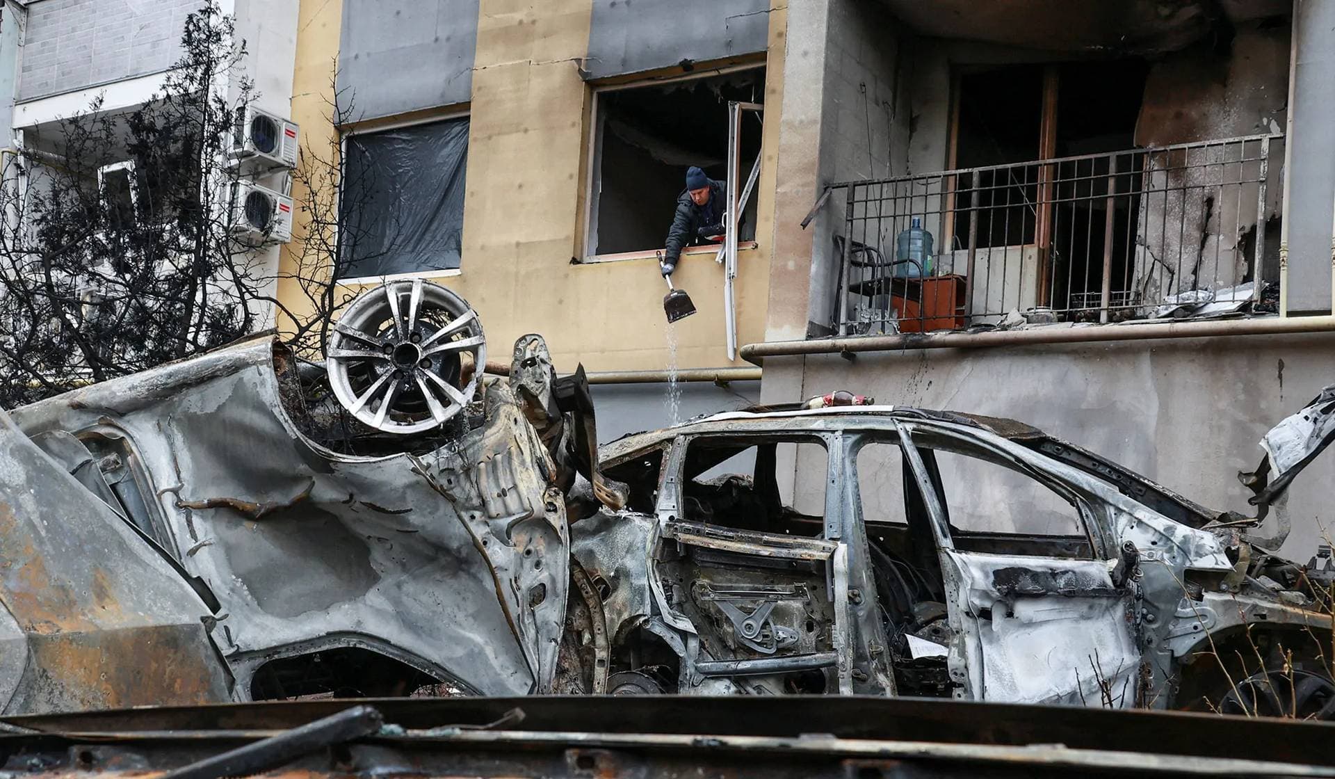 A resident removes debris from his apartment damaged by a Russian drone strike in Odesa