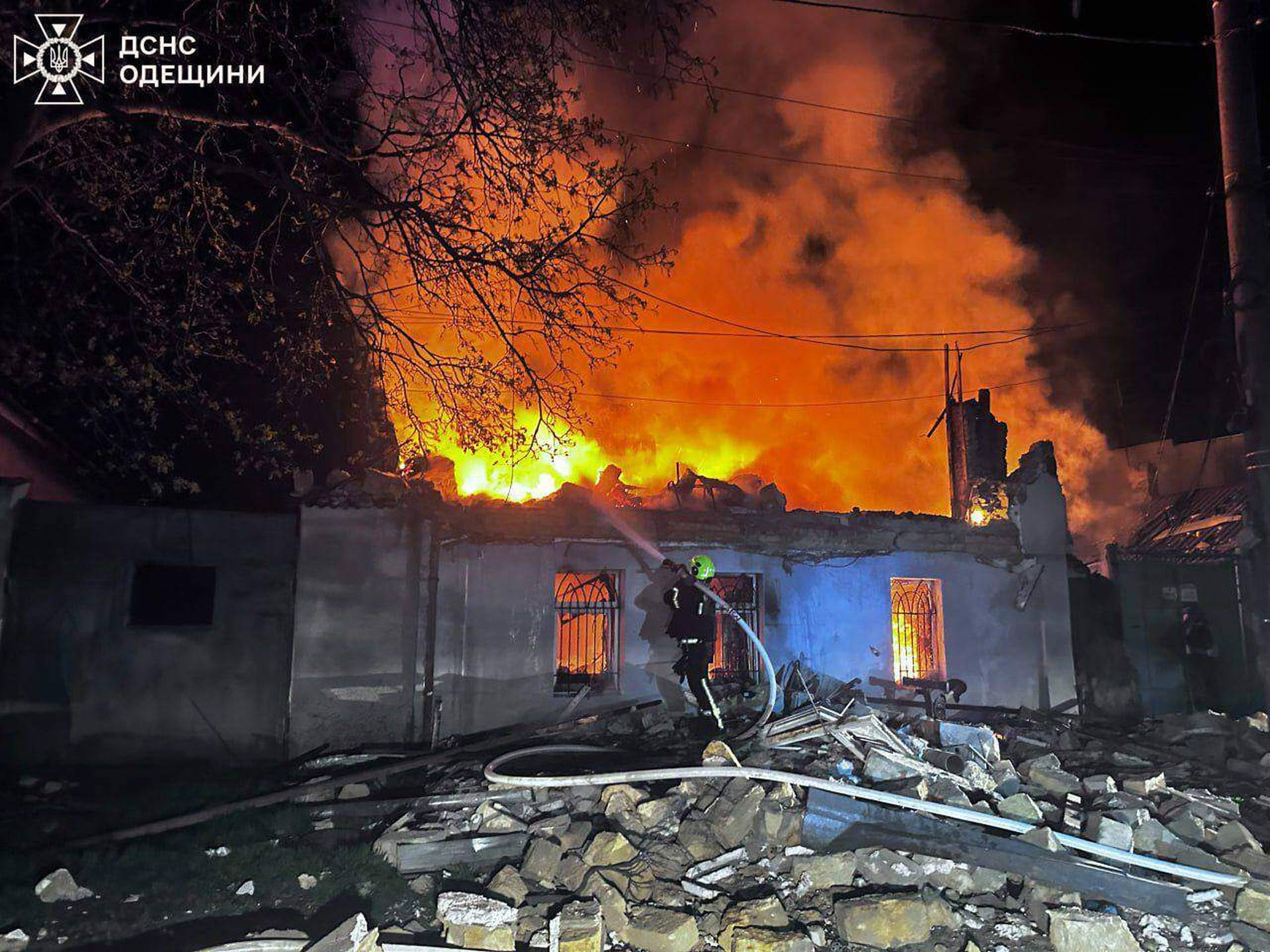 rescue workers put out a fire of building damaged by a Russian drone strike on Odesa