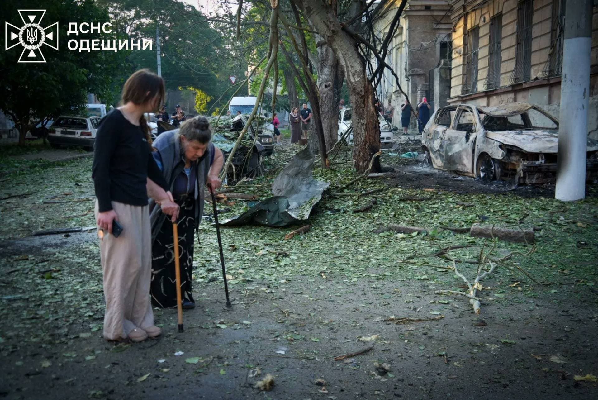 Residents leave the site of a Russian drone strike in Odesa