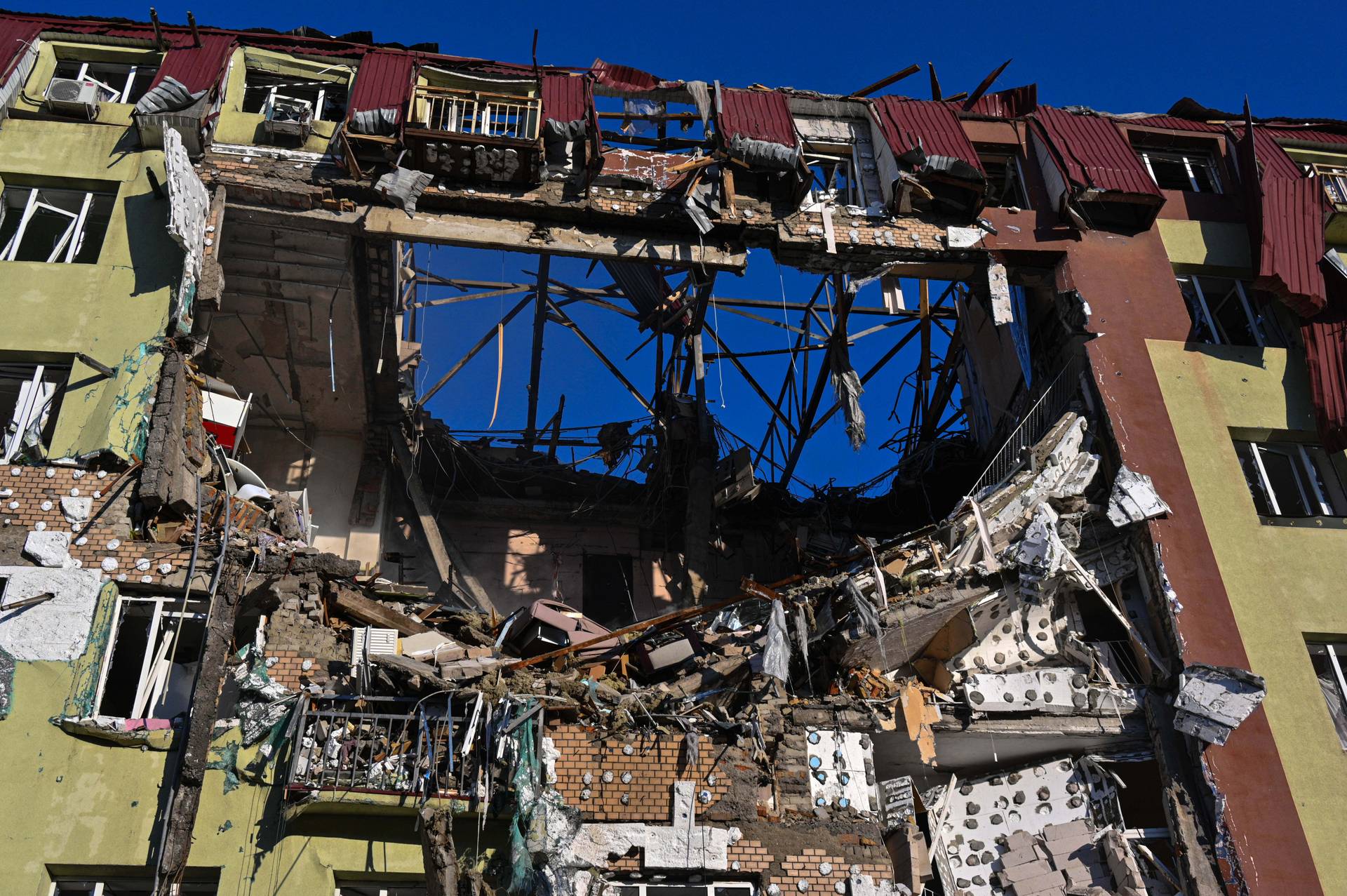 A rescue worker walks in front of residential building which was heavily damaged after a Russian strike in Odesa