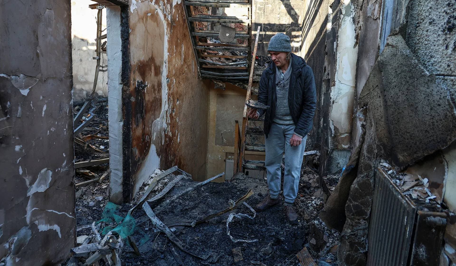 A resident stands inside of his house destroyed by a Russian drone strike in Odesa
