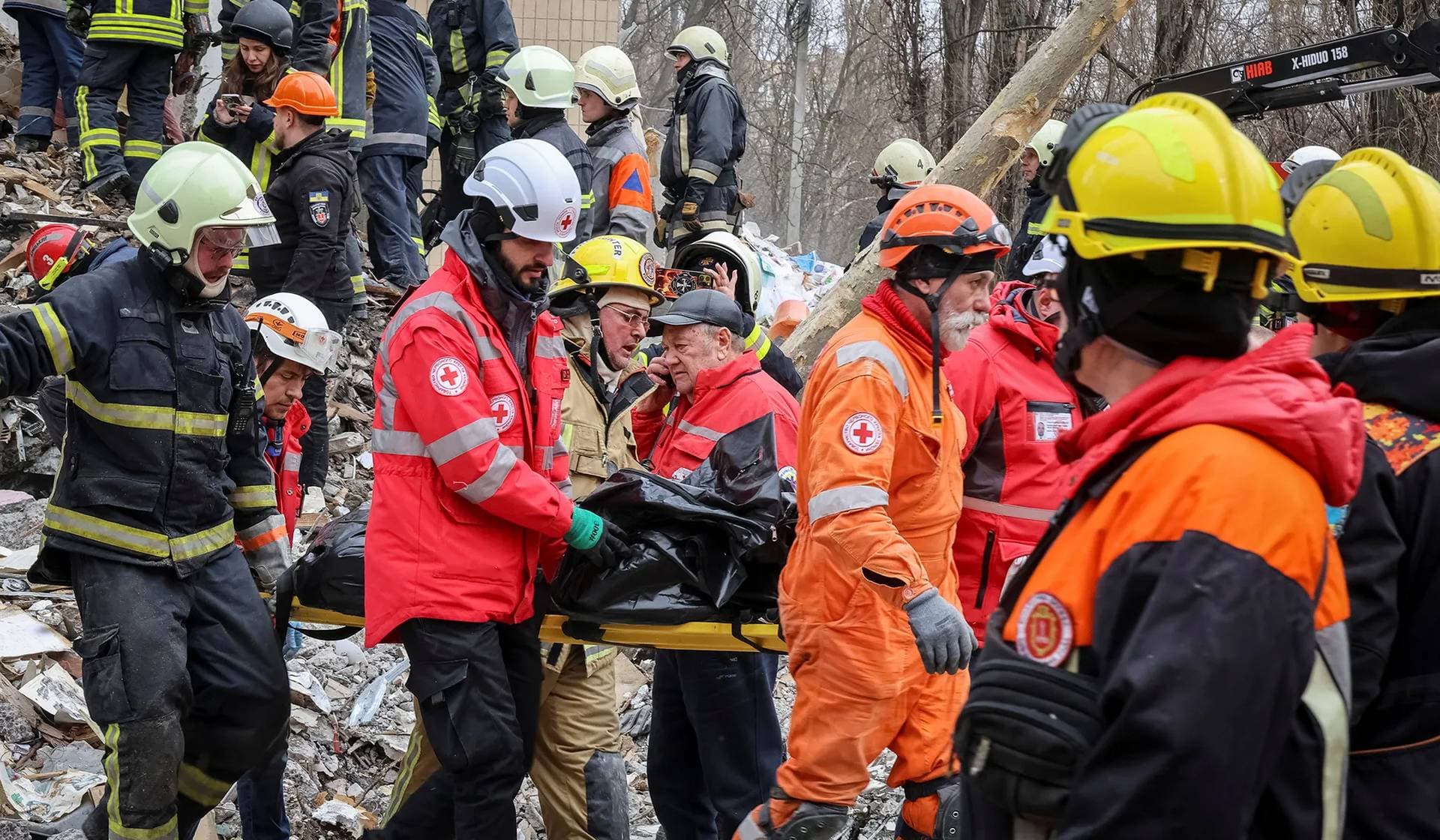Rescuers remove the body of a local resident at the site of a residential building heavily damaged by a Russian drone strike in Odesa