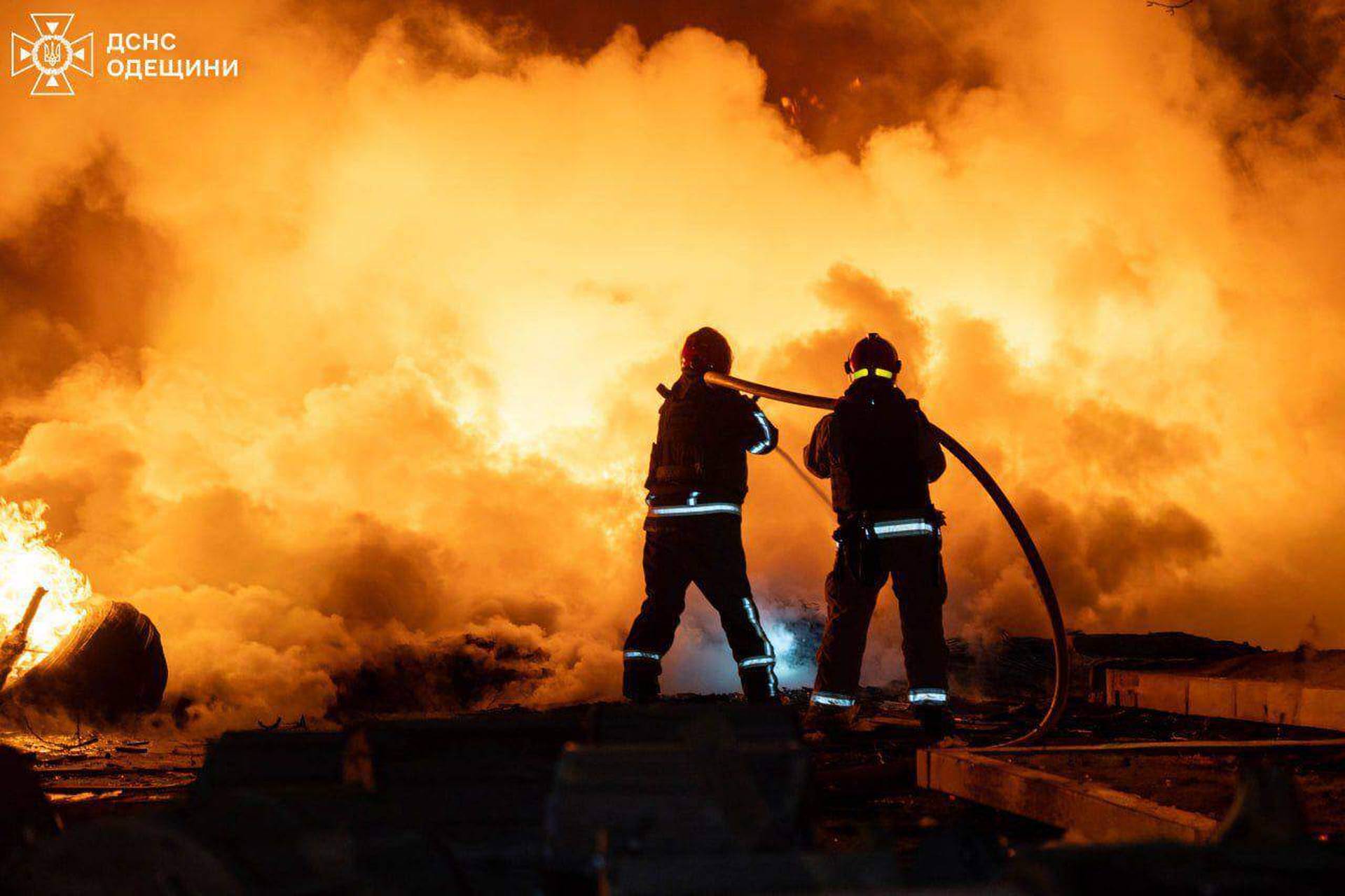 rescue workers put out a fire of building damaged by a Russian drone strike on Odesa