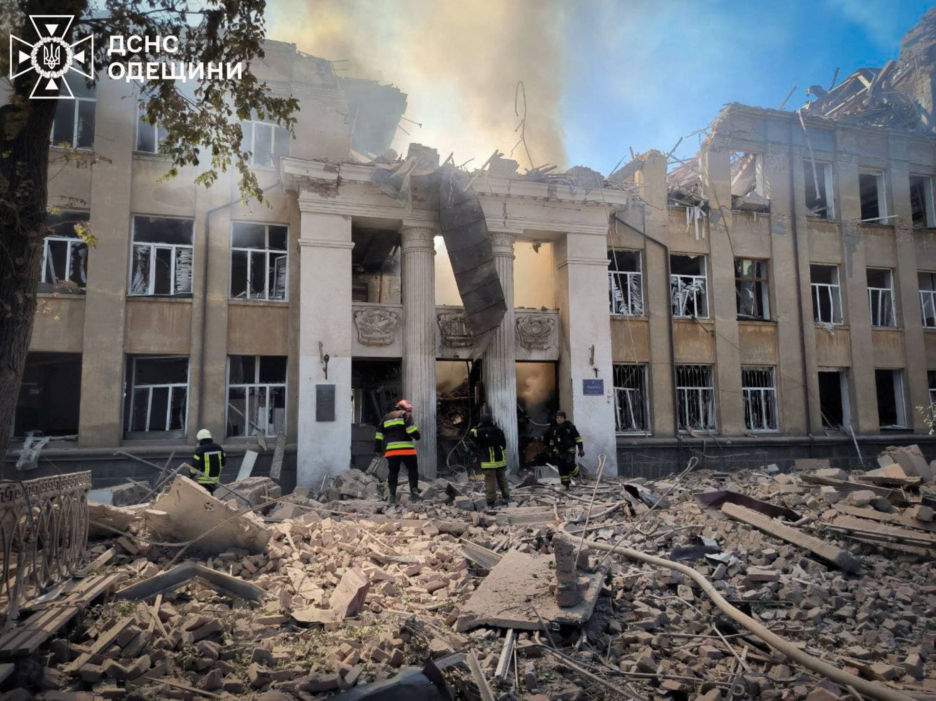 Firefighters work at the site of a lyceum building hit by a Russian missile strike in the town of Bilhorod-Dnistrovskyi