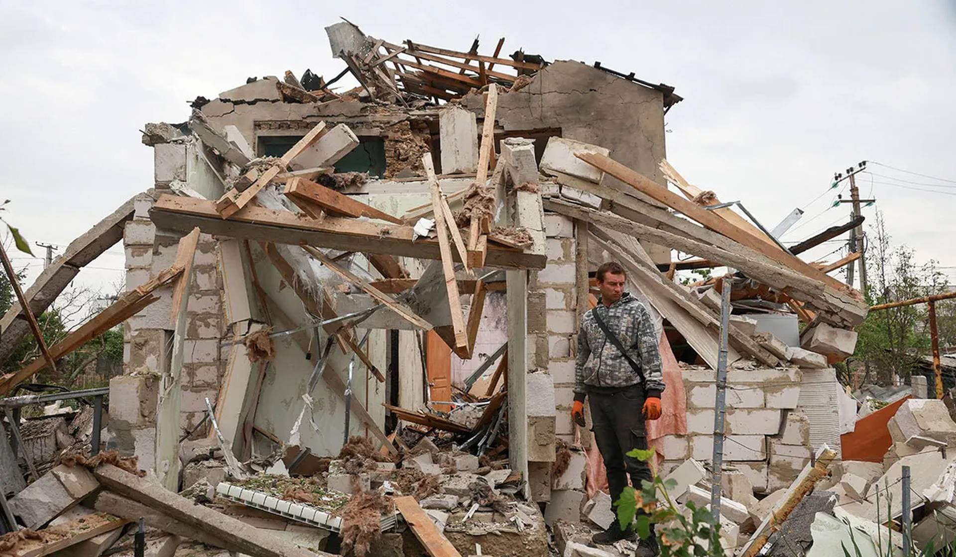 A resident stands next to his house heavily damaged by a Russian drone strike on the outskirts of Odesa