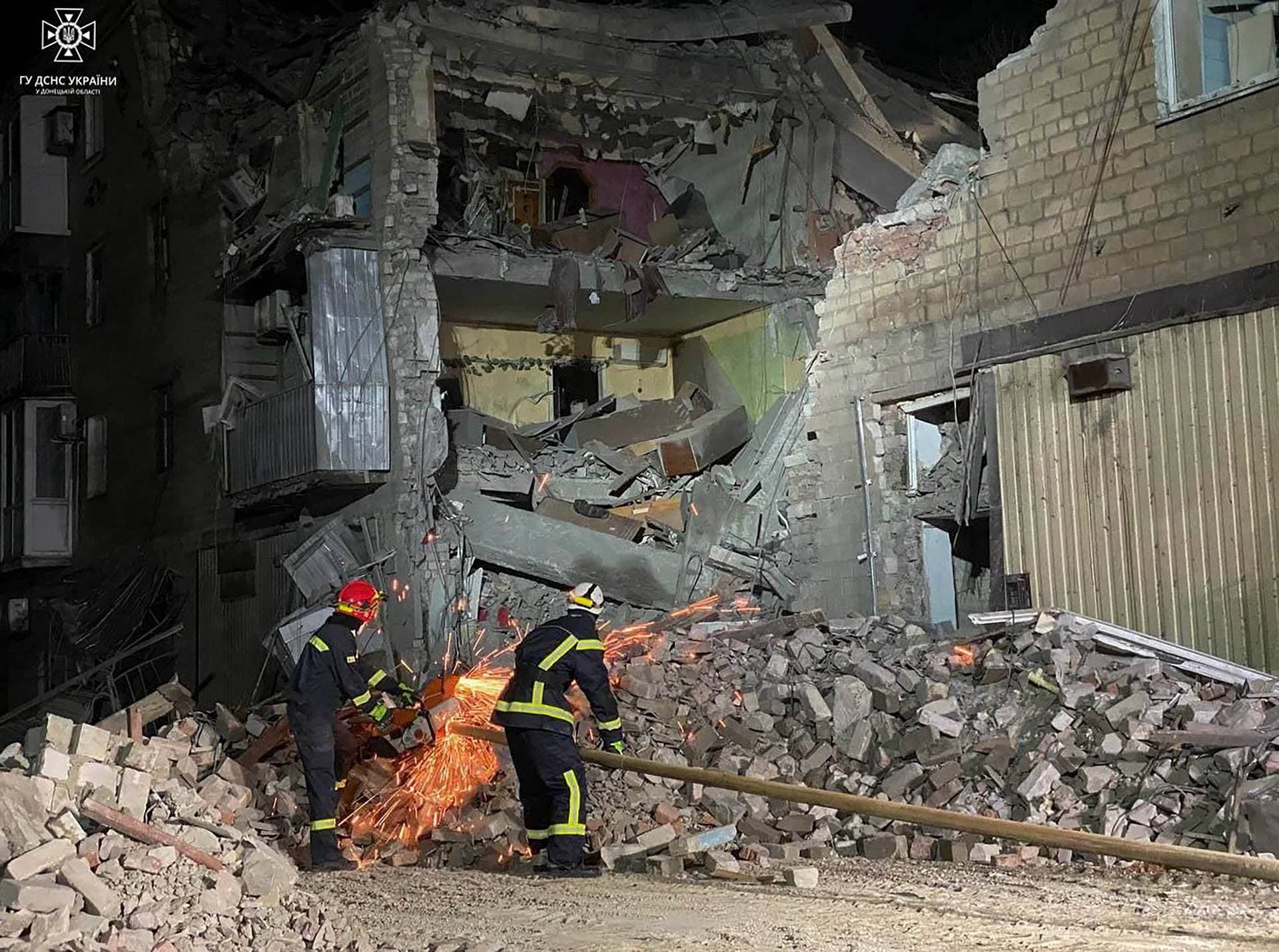 Rescuers work at a site of an apartment building damaged at night by Russian missile strike in Selydove