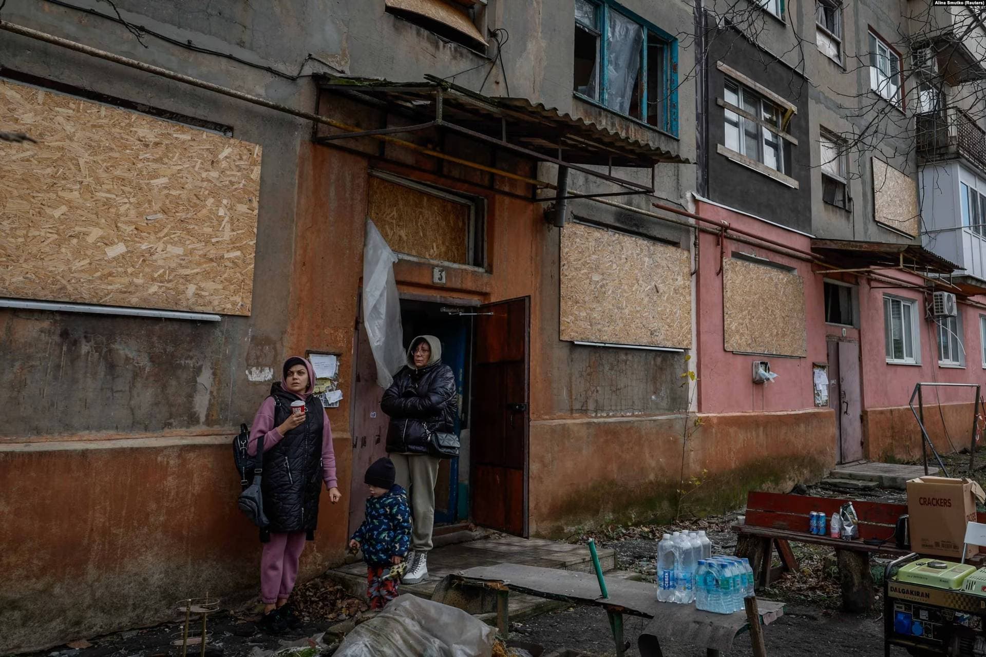 Residents watch as rescue workers work at the site.on Selydove