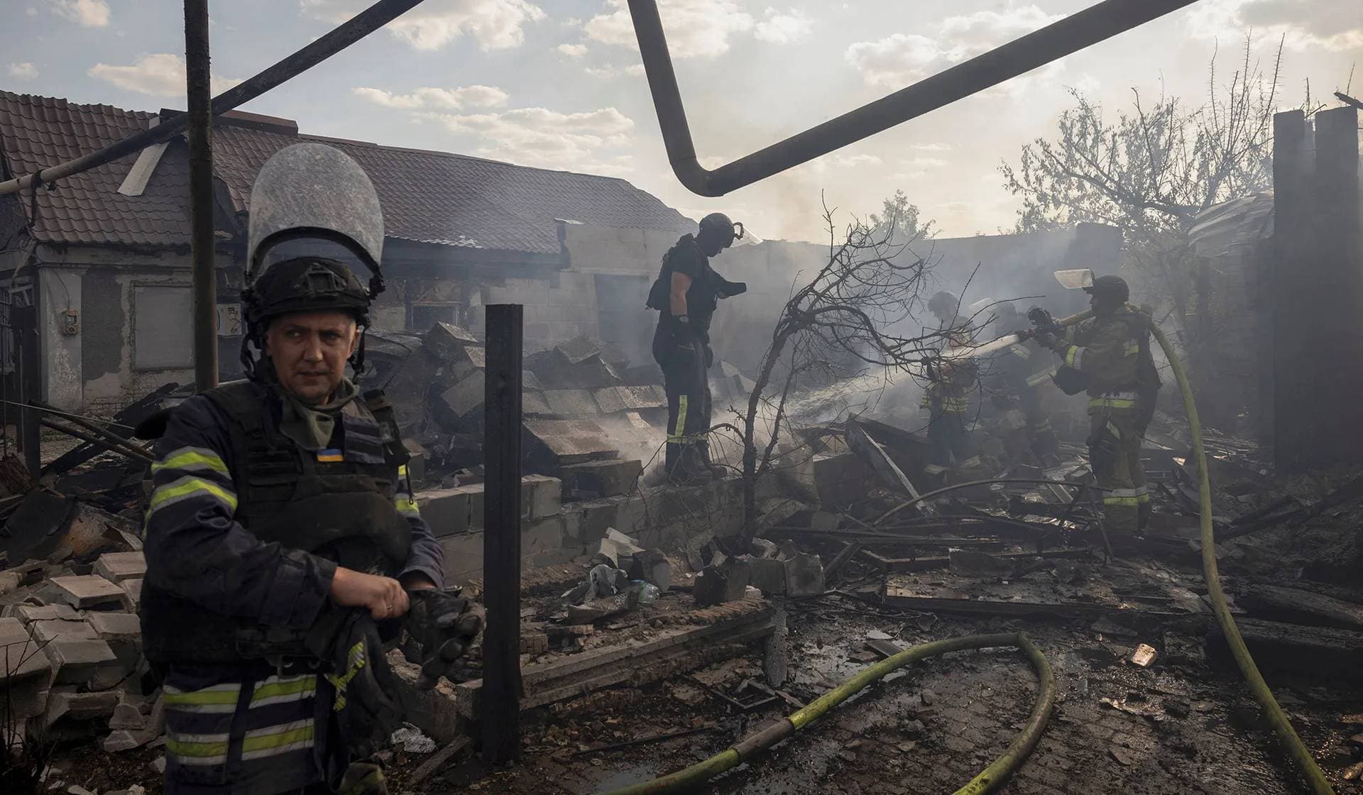 A local man rescues a pet bird from a house that was destroyed after a Russian strike on a residential area in Pokrovsk