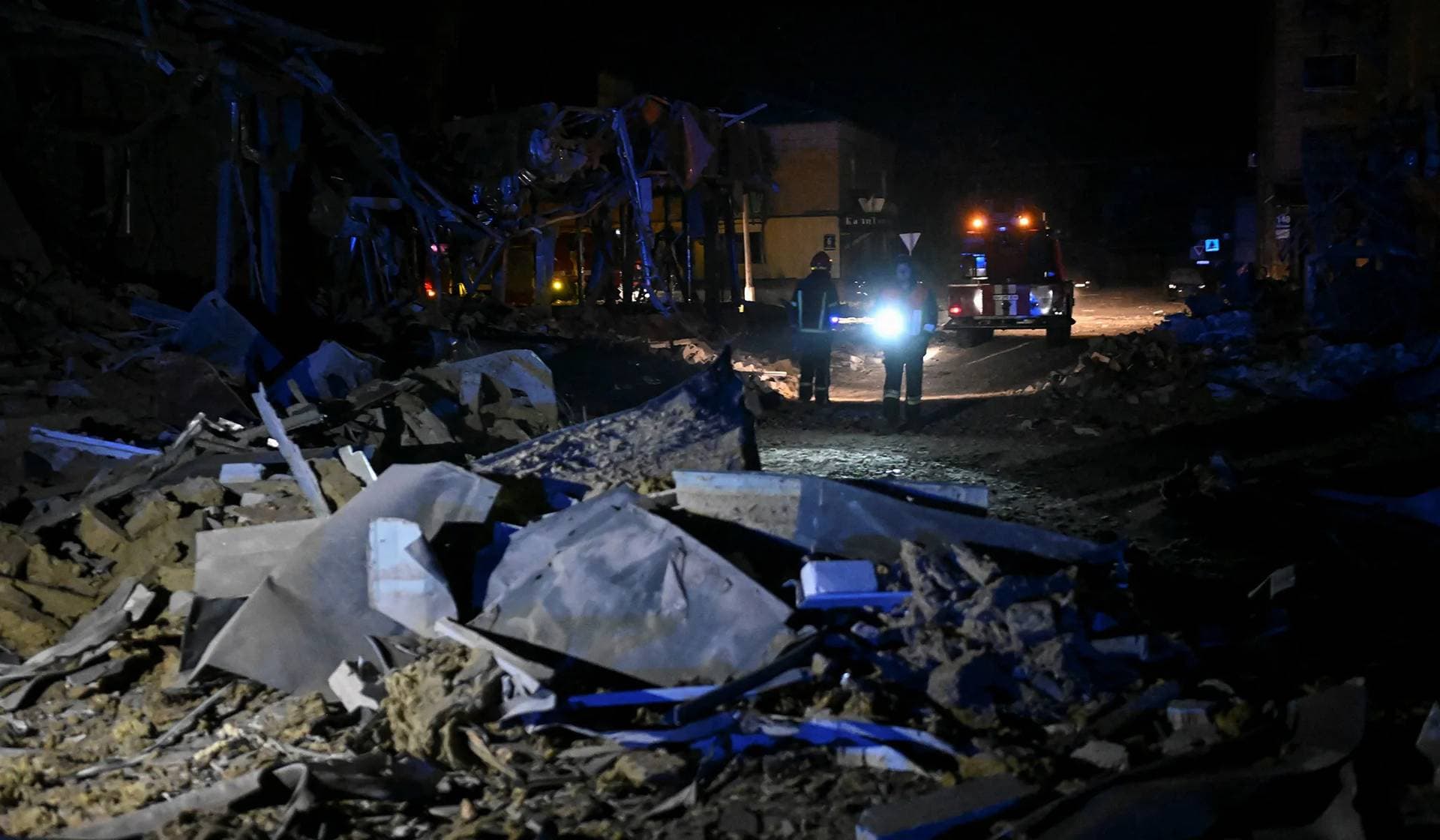 Rescuers work at the site where a building was destroyed during a Russian missile strike in Pokrovsk
