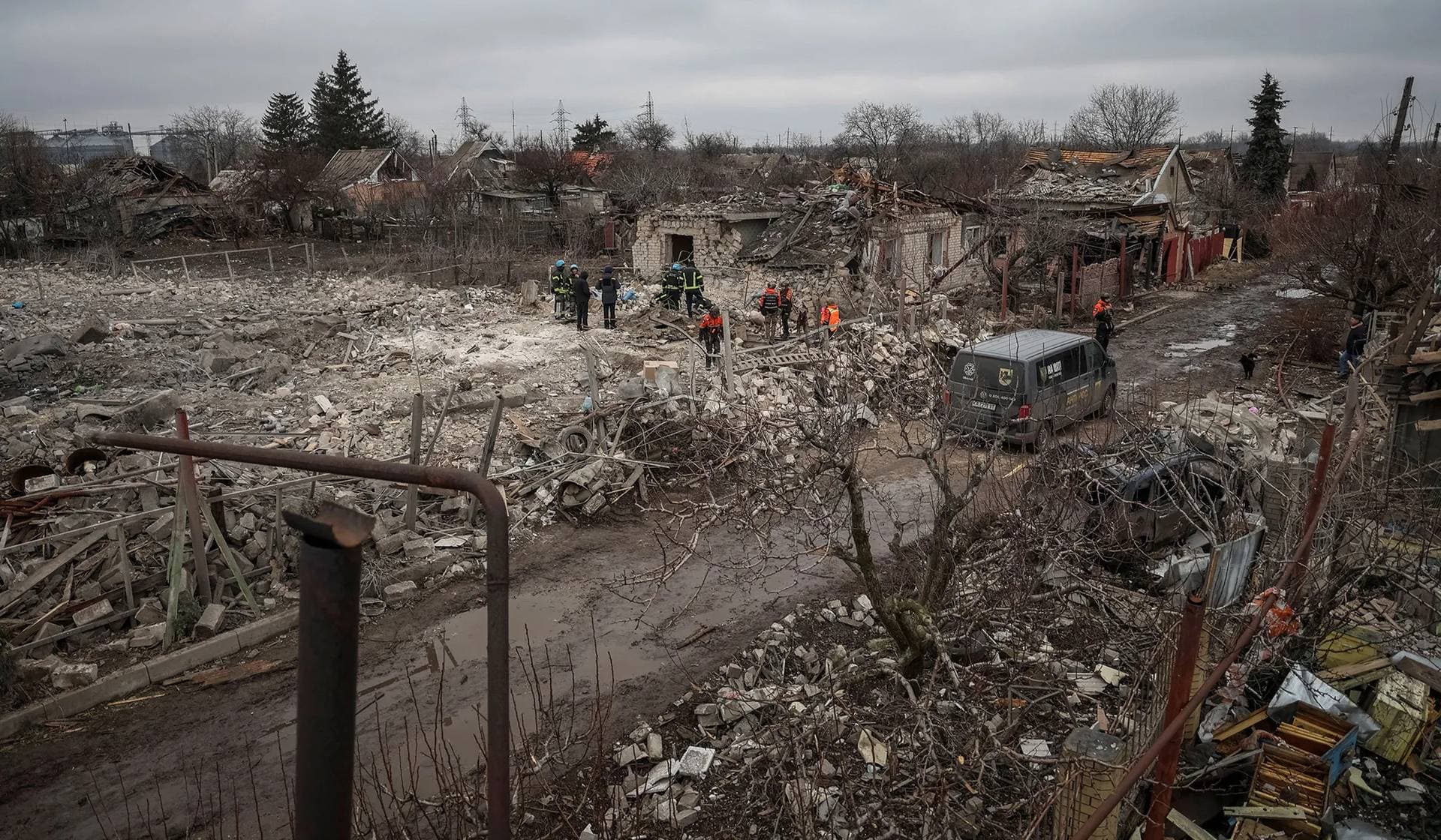 Rescuers work at the site of a Russian missile strike in an area in the village of Rivne near Pokrovsk