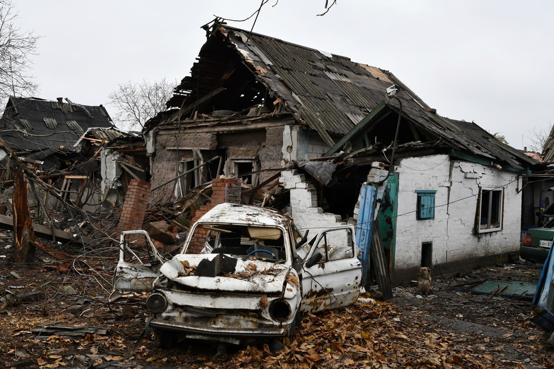 A damaged Soviet-era Ukrainian car Zaporozhets is seen next to a destroyed apartment building after Russian shelling in Pokrovsk