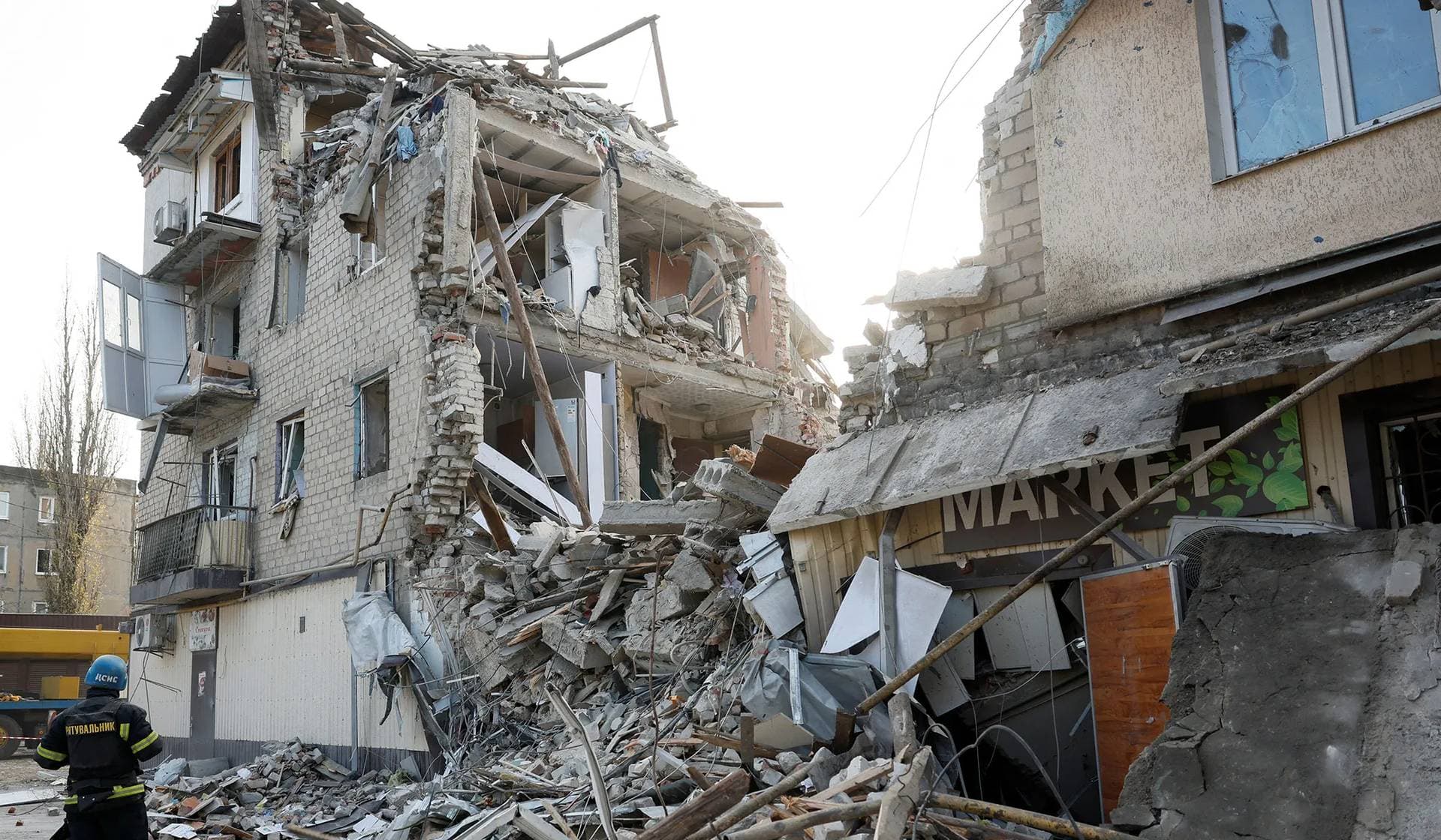 A rescuer works at the site of residential houses heavily damaged by a Russian missile strike in Selydove