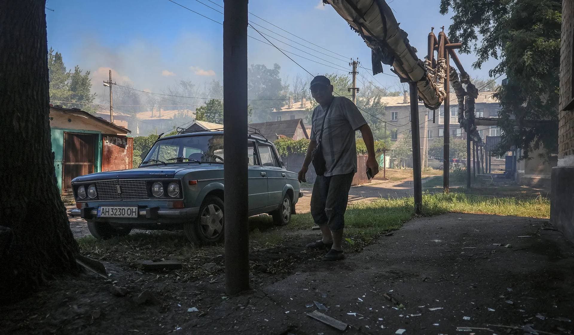 A resident leaves the site of an apartment building hit by Russian drone strike in Bilozerske