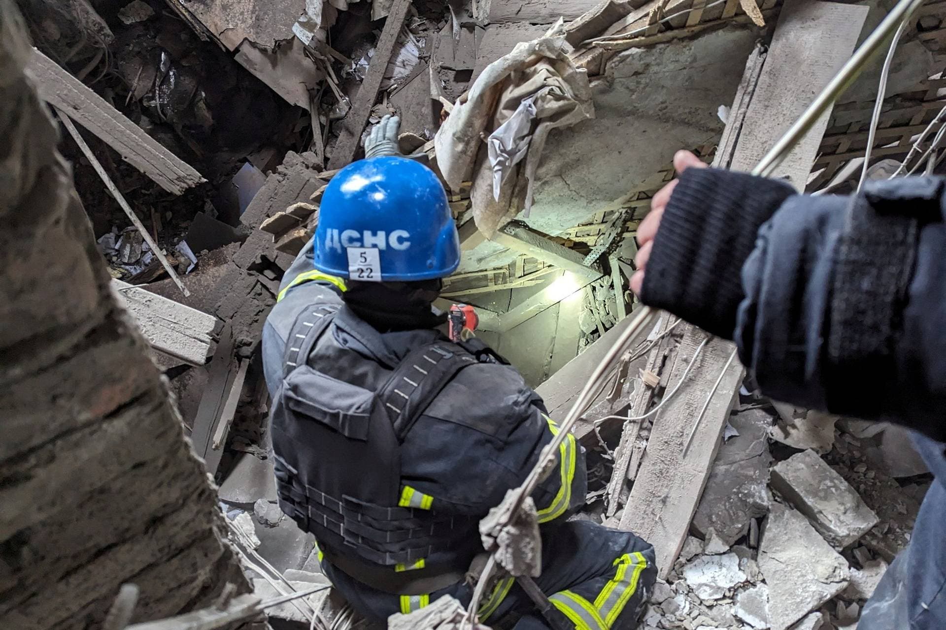 Rescuers work at the site of an administrative building damaged by a Russian missile strike in Pokrovsk