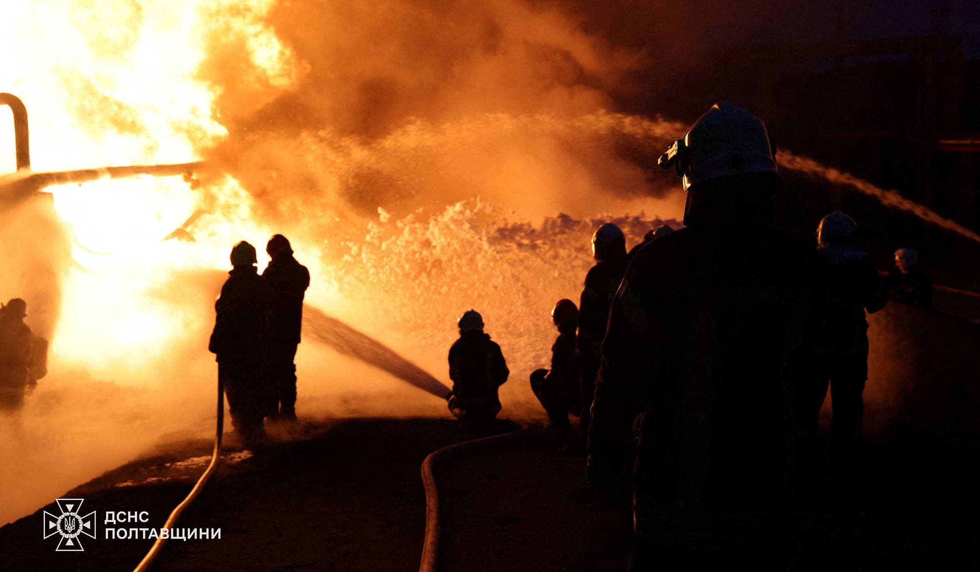 Firefighters work at the site of a Russian drone and missile strike in the Poltava Region