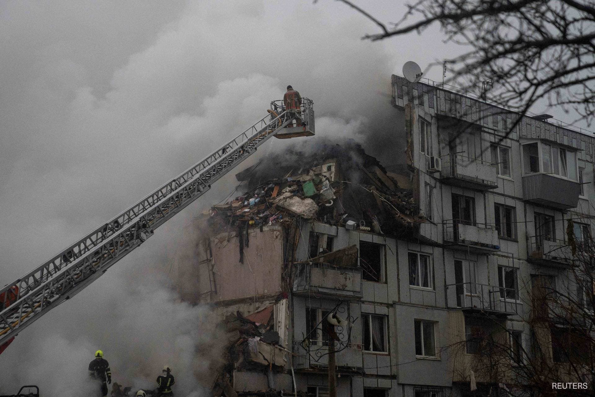 Rescuers work at the site of an apartment building hit by a Russian missile strike in Poltava