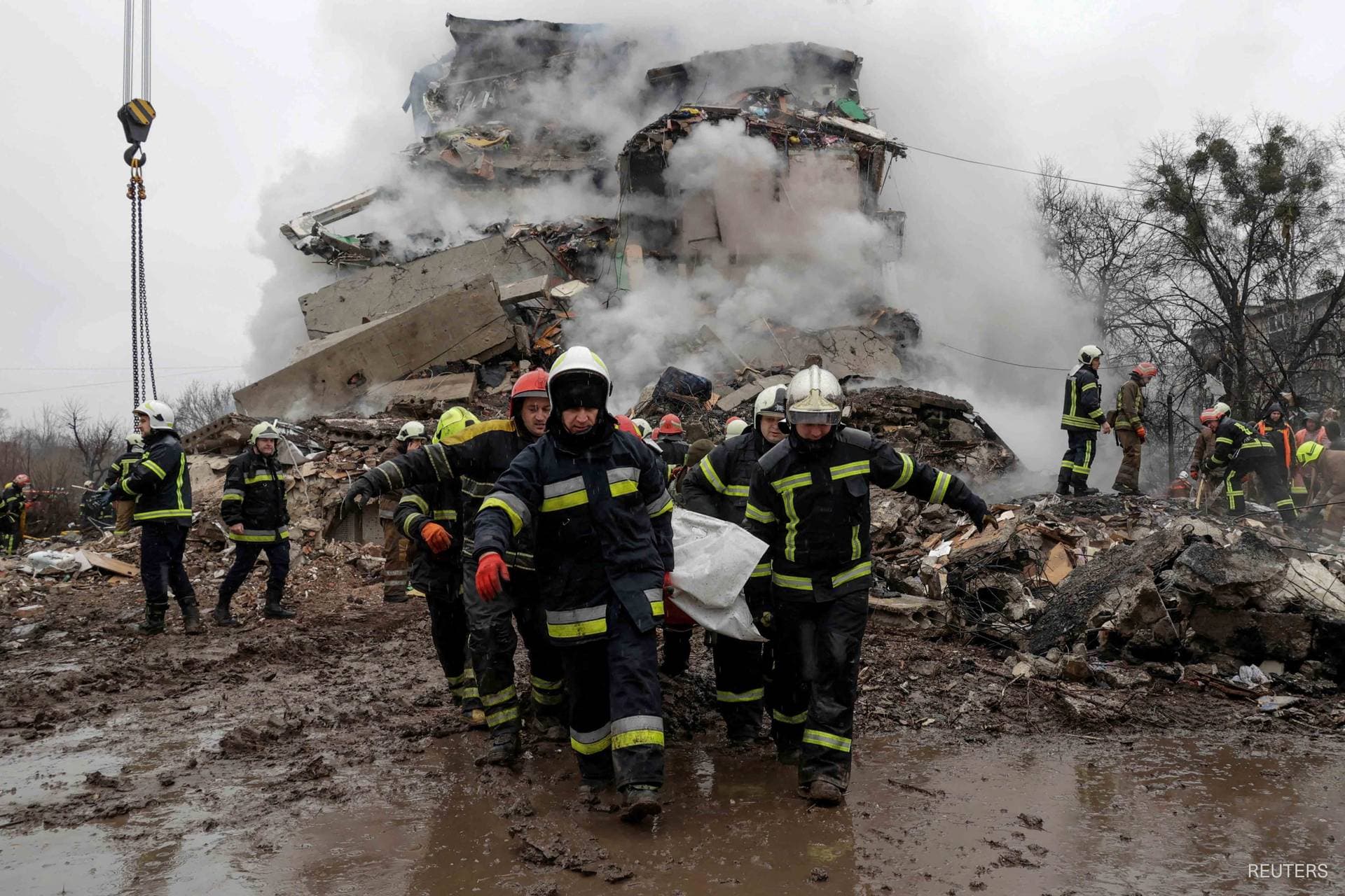 Rescuers work at the site of an apartment building hit by a Russian missile strike in Poltava