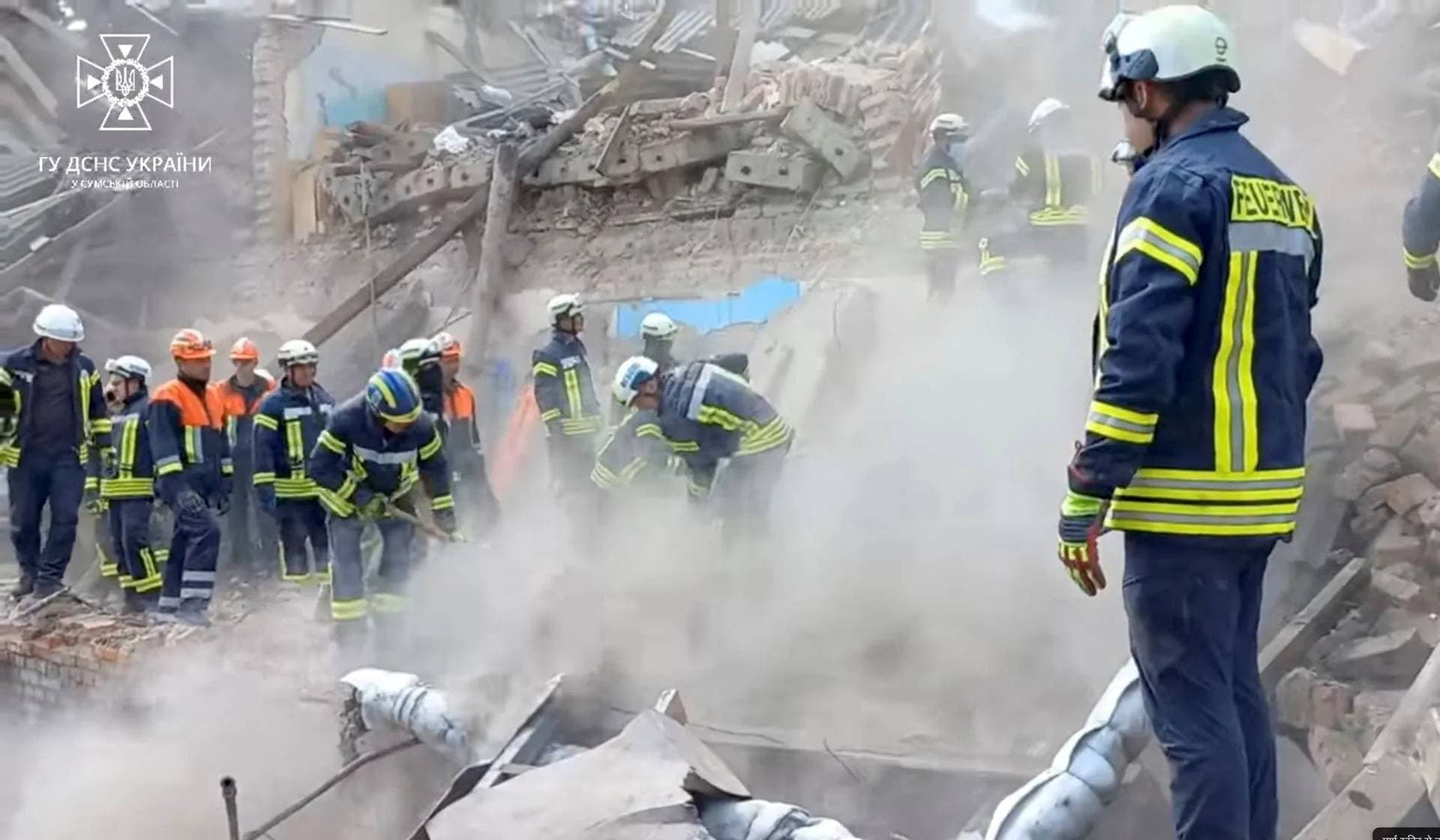 Rescuers work at the site of a Russian drone strike in Romny