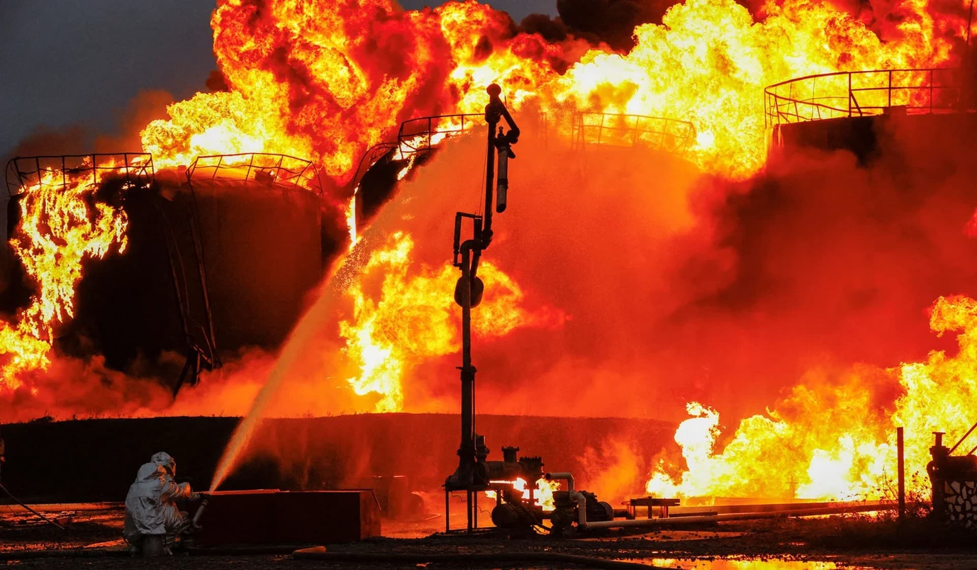 Firefighters work to extinguish fire following recent shelling at an oil storage facility in Shakhtarsk