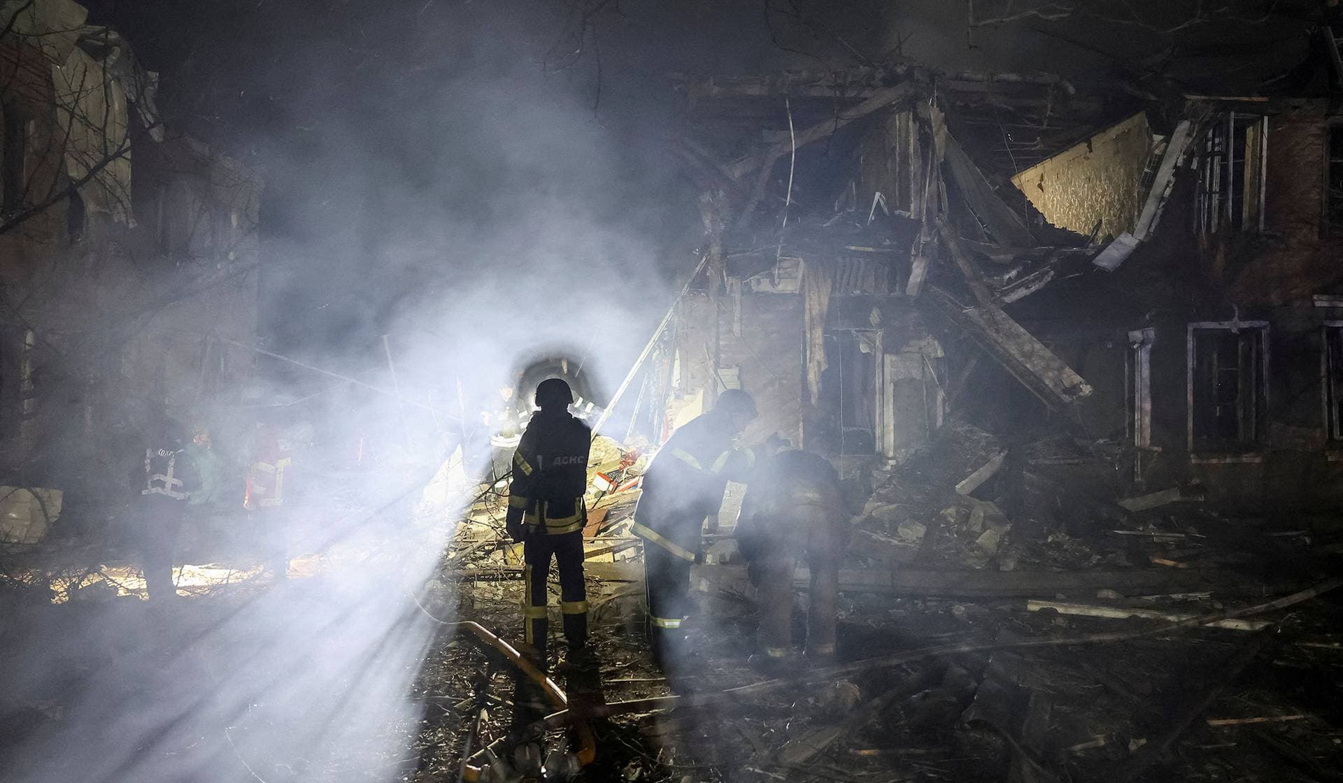 Rescuers work at the site of apartment buildings hit by a Russian air strike in Sloviansk