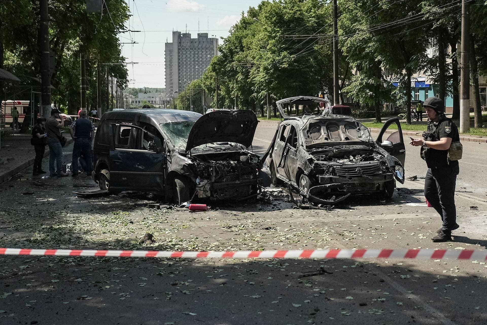 Police officers stand at the site of Russian missile strike in Sumy