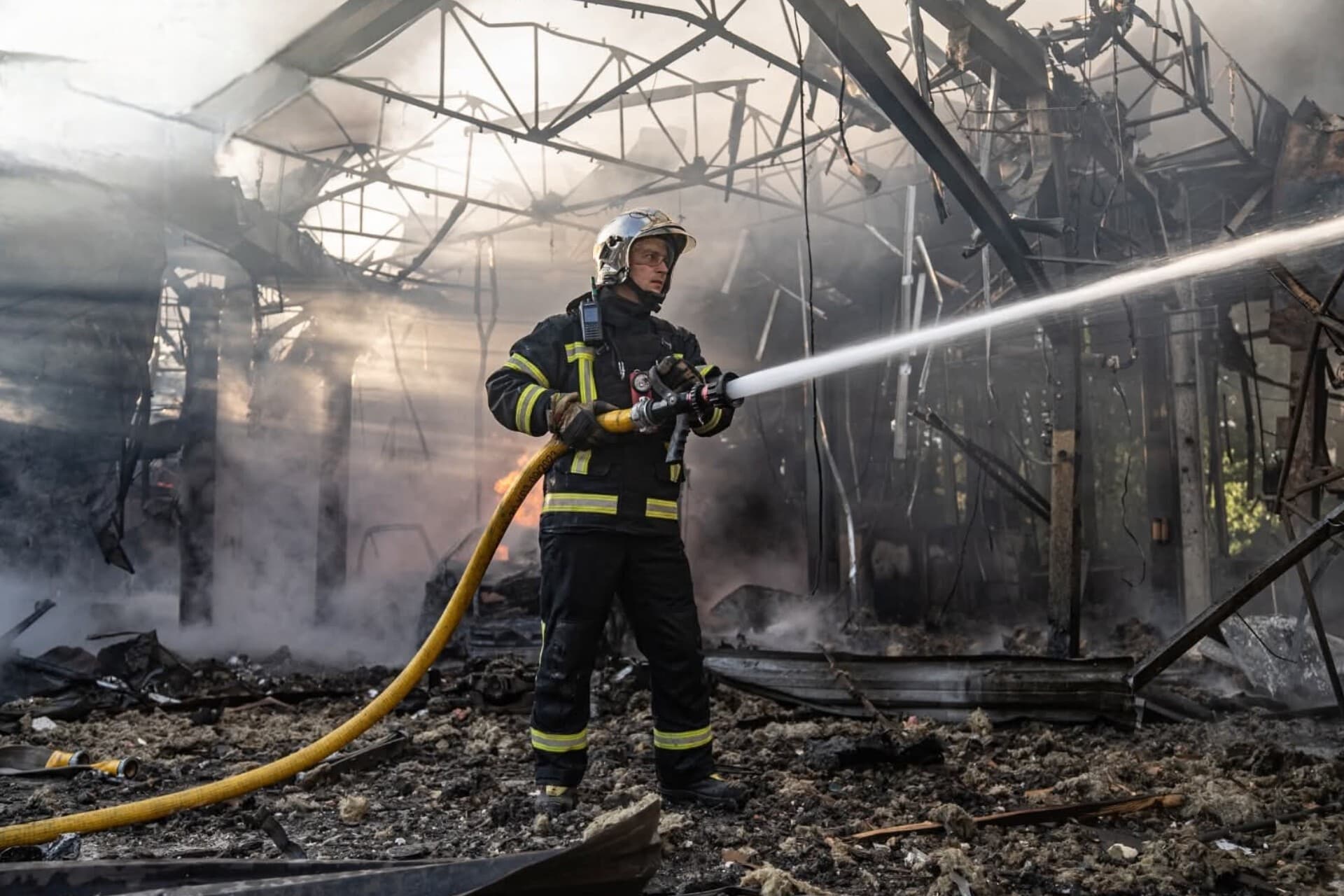 A firefighter works at the site of a Russian drone strike in Sumy