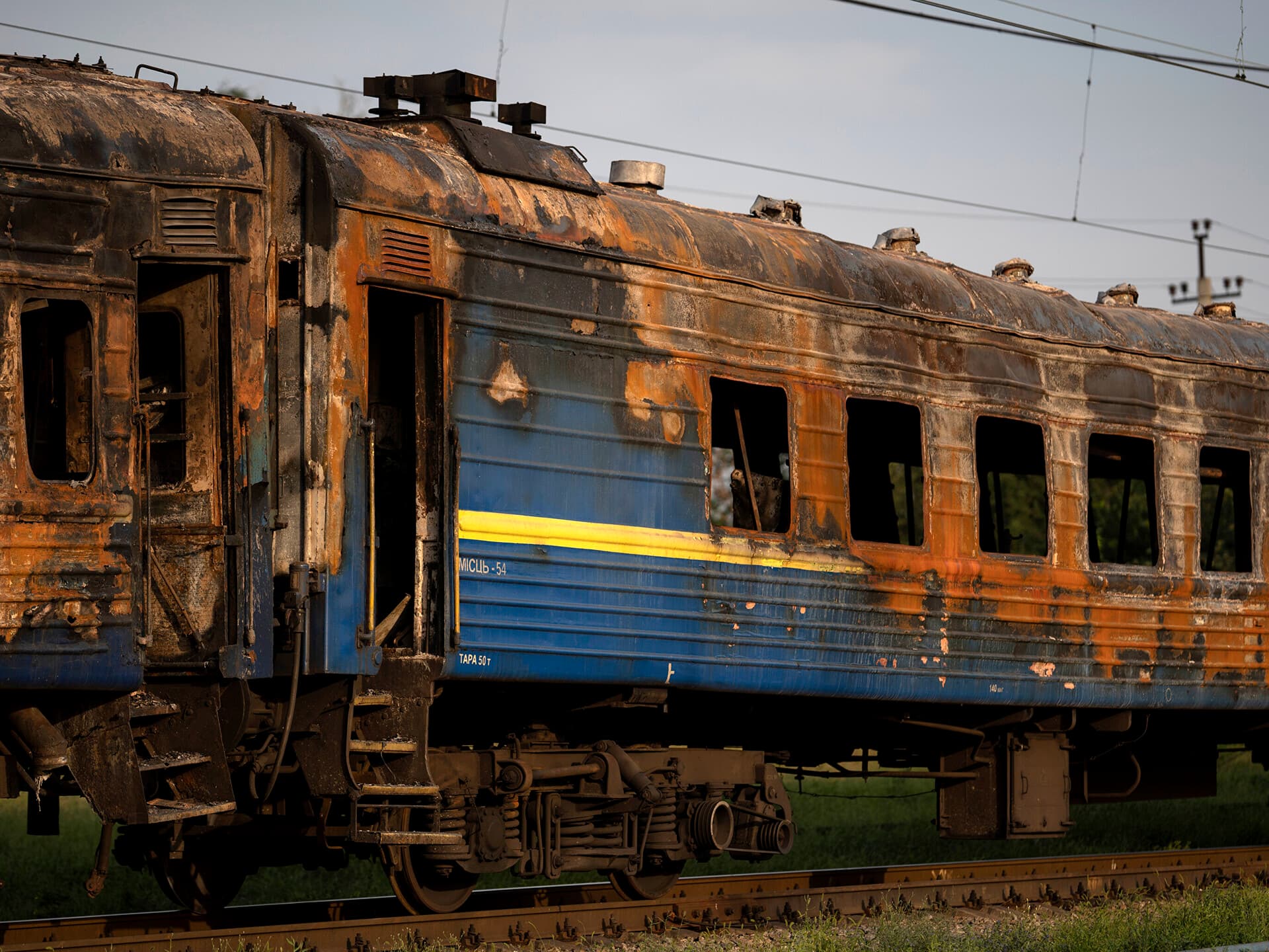 A heavily damaged train is seen at a train station after a Russian attack Wednesday during Ukraine's Independence Day in the village Chaplyne